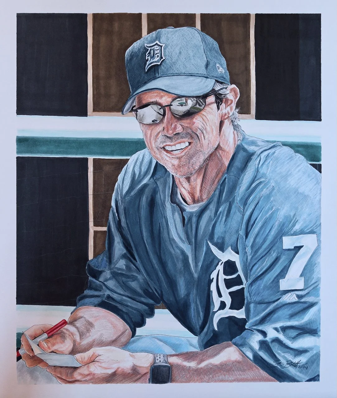Colorful portrait of a smiling man wearing a Detroit Tigers cap, sunglasses, a gray jacket with a tiger emblem, and holding a red marker and a notepad.