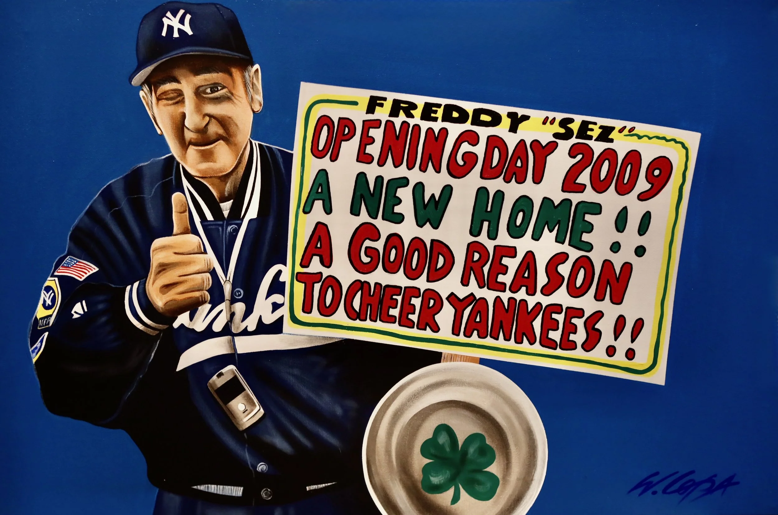 A cardboard cutout of a person in a New York Yankees cap giving a thumbs-up, holding a colorful sign that says 'FREDDY 'SEZ' OPENING DAY 2009 A NEW HOME! A GOOD REASON TO CHEER YANKEES!' with a bowl of green four-leaf clovers in front of the person.