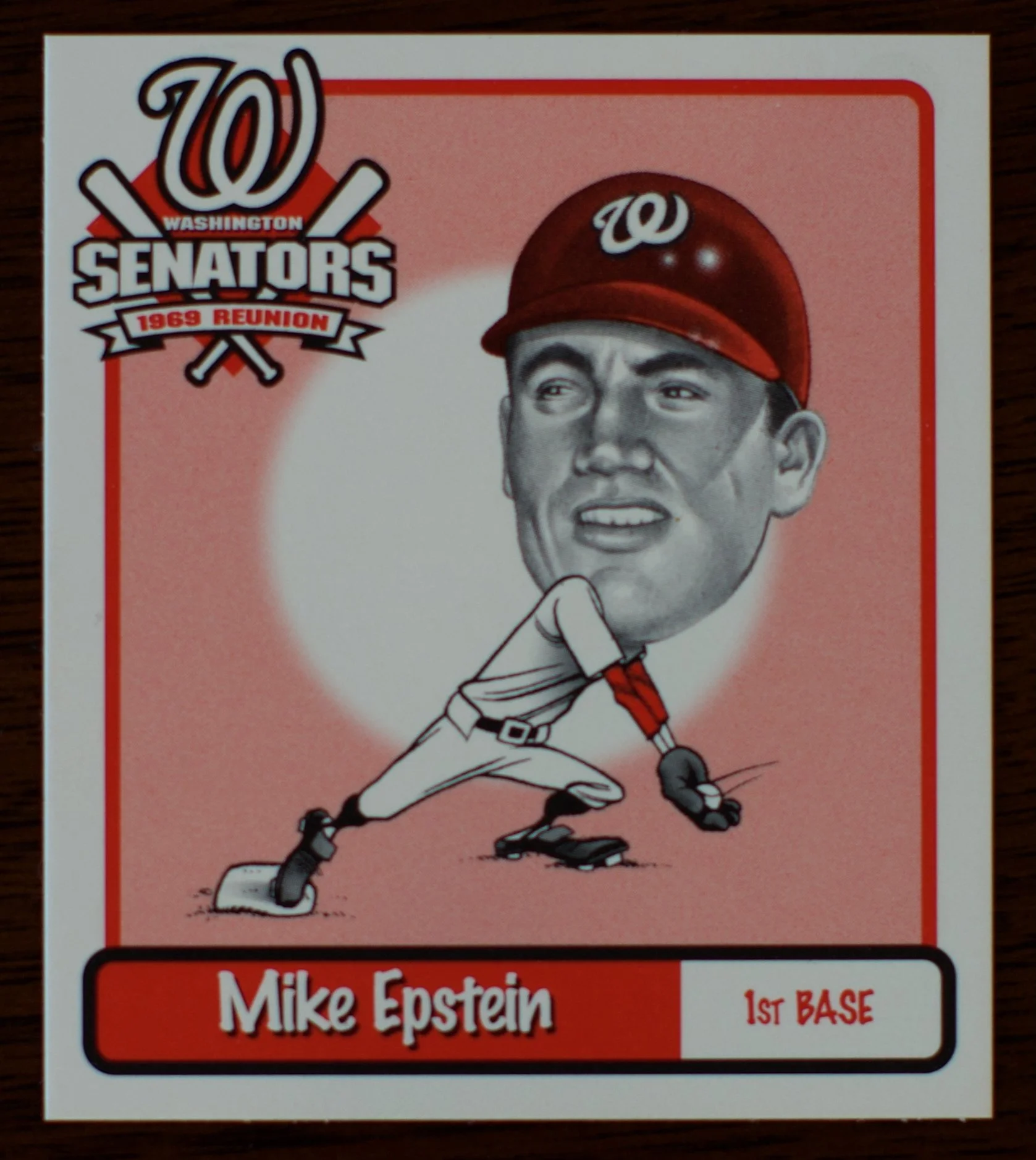 Illustration of a baseball player in a batting stance wearing a helmet with a Washington Nationals logo, labeled as part of the 1989 reunion for Washington Senators. The player is named Mike Epstein and is positioned at first base.