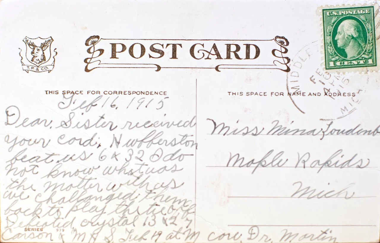 A vintage postcard with a green one-cent postage stamp featuring George Washington. The postcard is addressed to Miss Mina Founden in Mople Rapids, Michigan. The handwritten message is dated July 16, 1915, and mentions receiving a cough, and a game played with crystal beads.