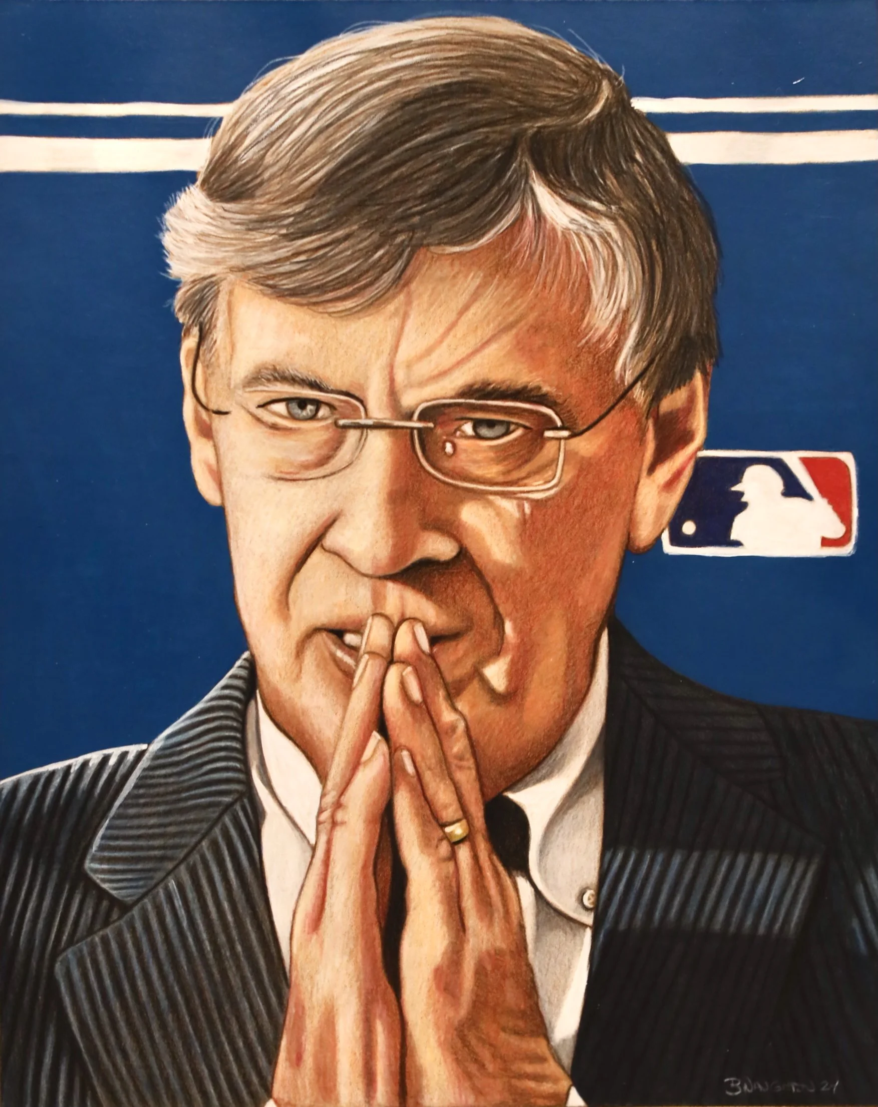 A man with gray hair and glasses, wearing a pinstripe suit and a gold ring, touching his lips with his fingers, against a blue background with the MLB logo.