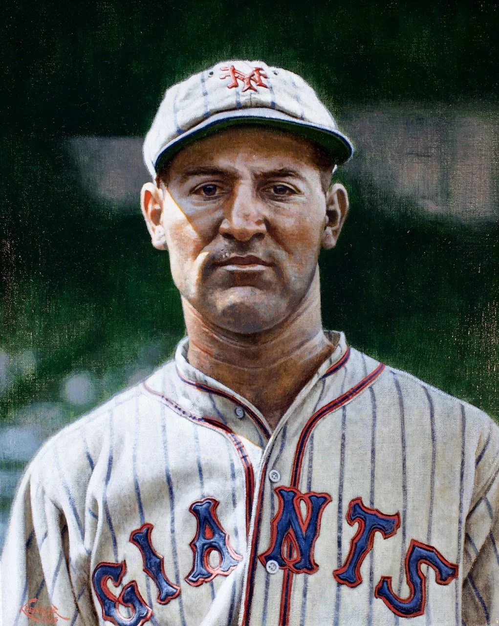 Black-and-white portrait of a man in a vintage New York Giants baseball uniform and cap, standing outdoors with a blurred natural background.