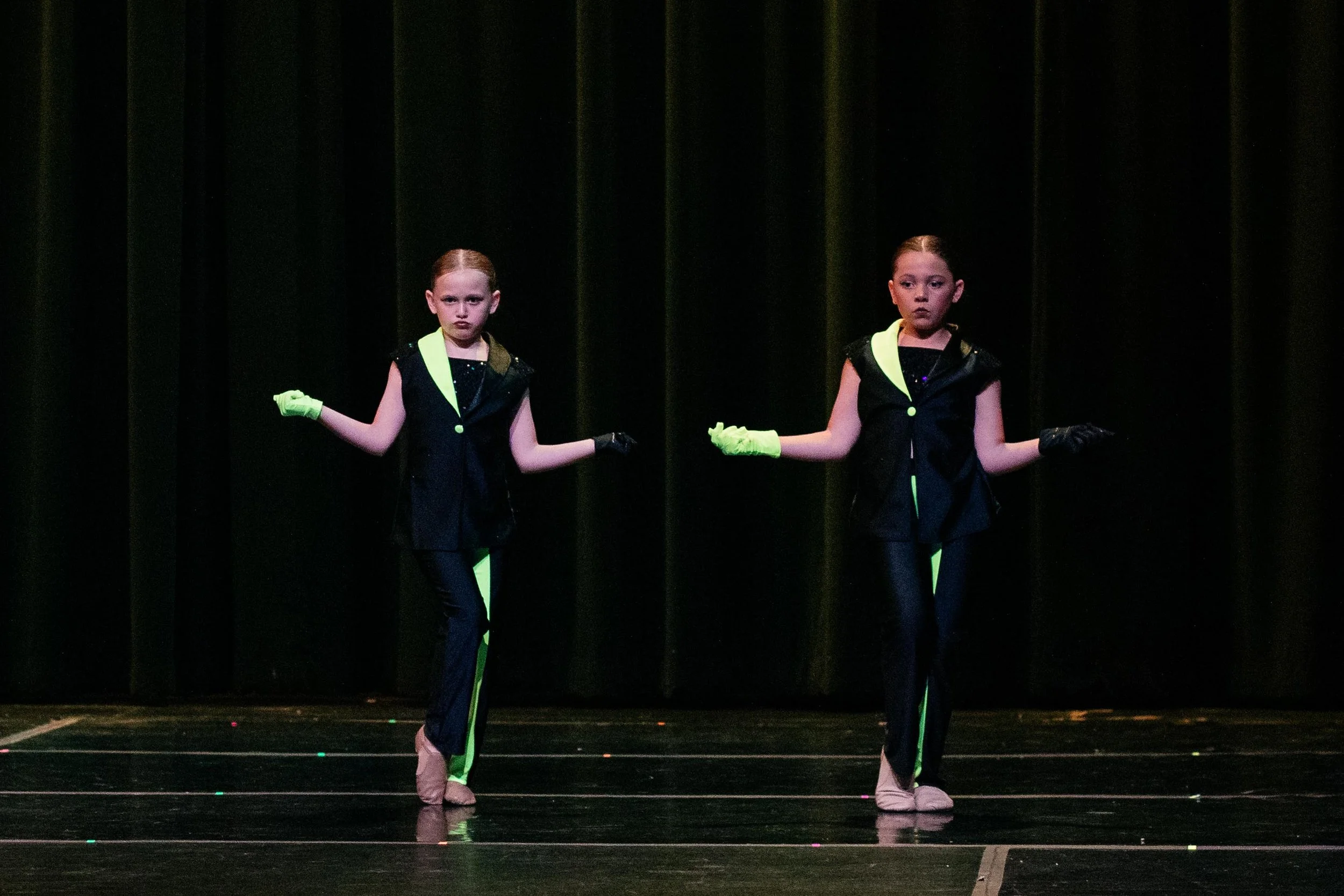 Dance Factory East competition team performing on stage during a dance competition.