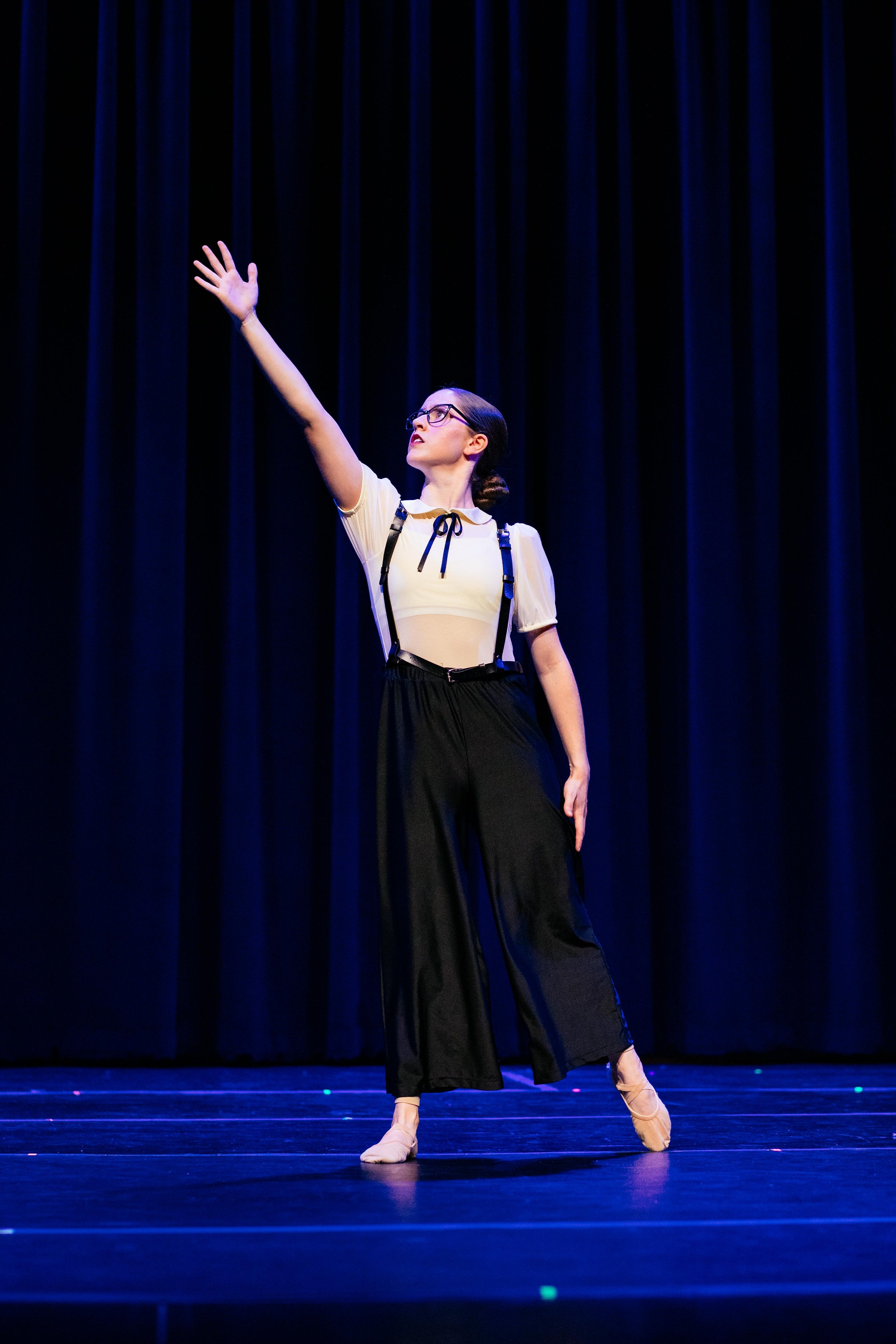 Dance Factory East competition team performing on stage during a dance competition.