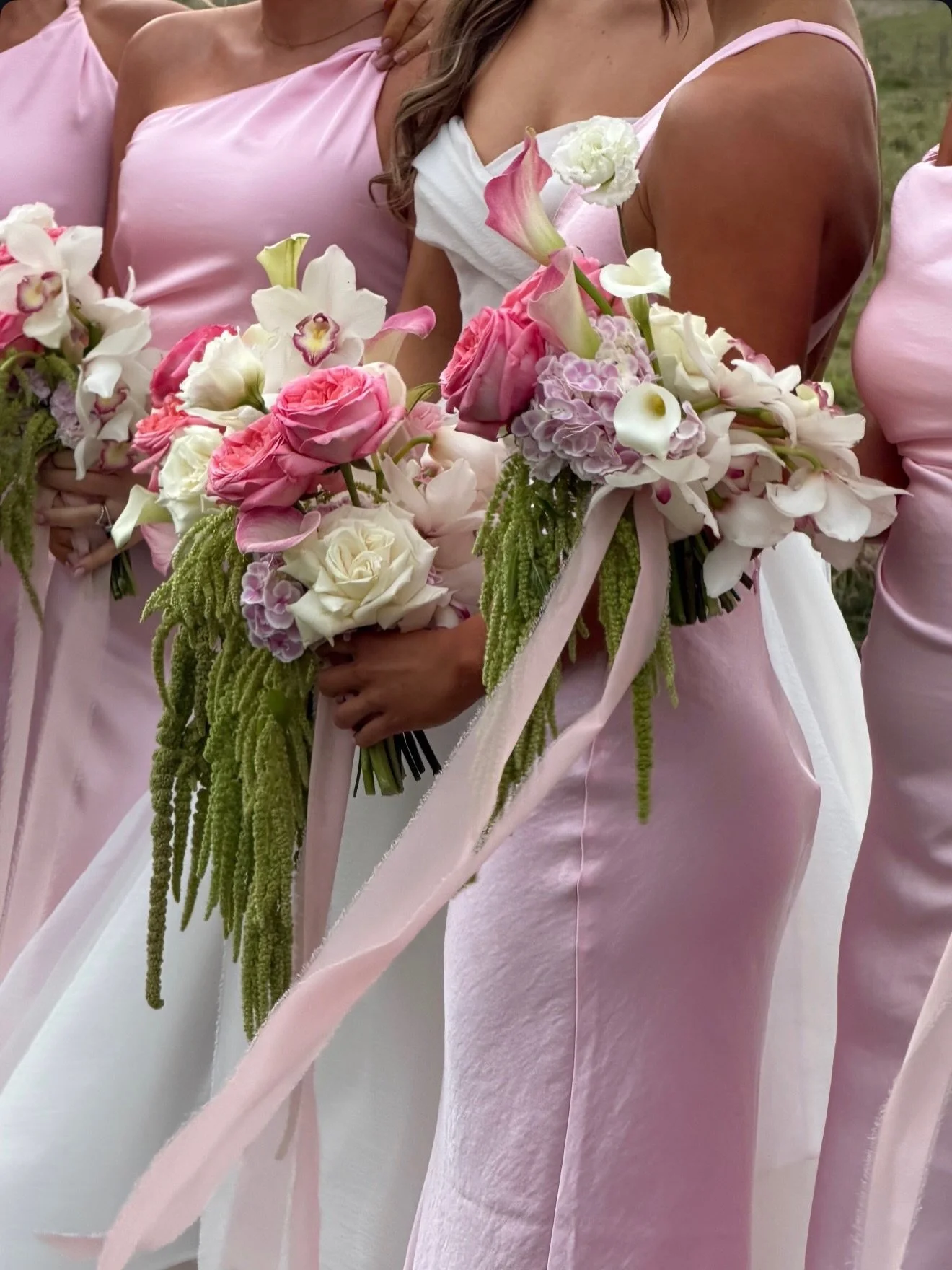 Your bouquet has more to do with your dress than you might think.

Your bouquet shouldn&rsquo;t be chosen on its own.
It should be considered alongside the dresses and overall styling.

The neckline, silhouette, fabric, train and veil all influence t