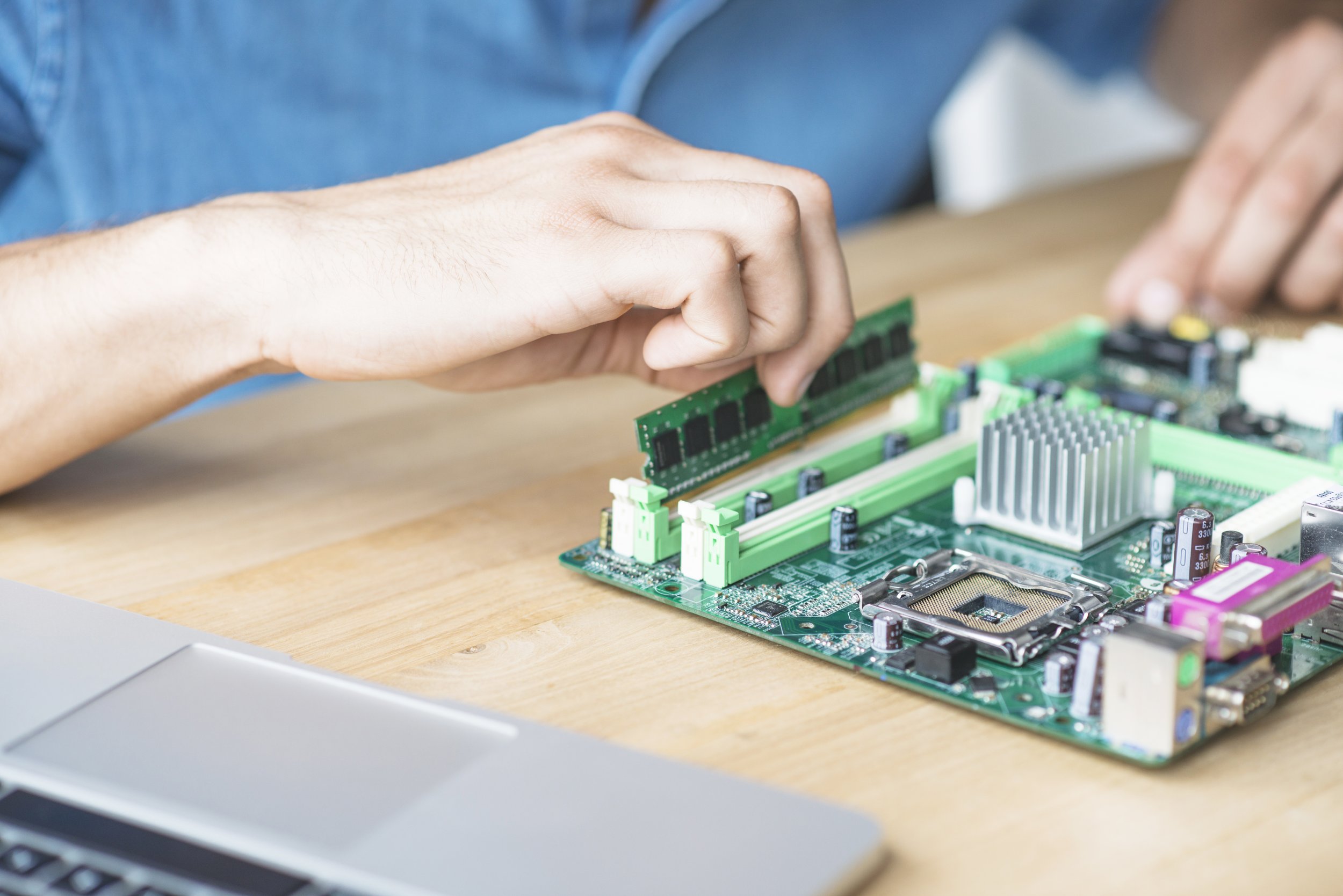 it-technician-repairing-hardware-equipment-s-wooden-table.jpg