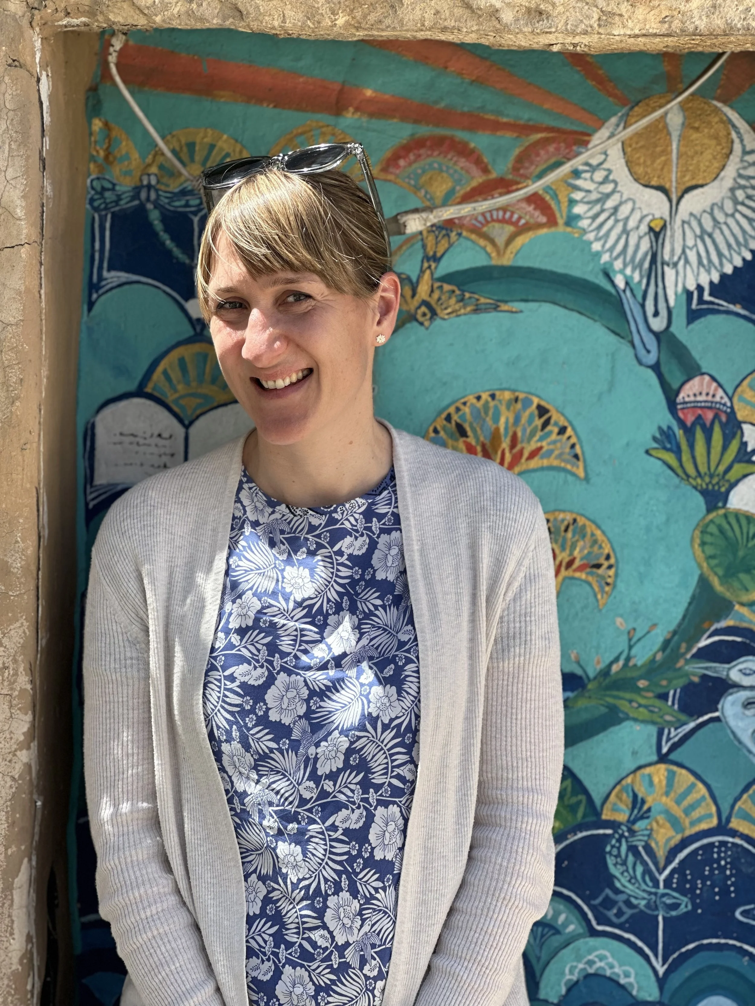 Photo of the author in front of a beautiful blue patterned door
