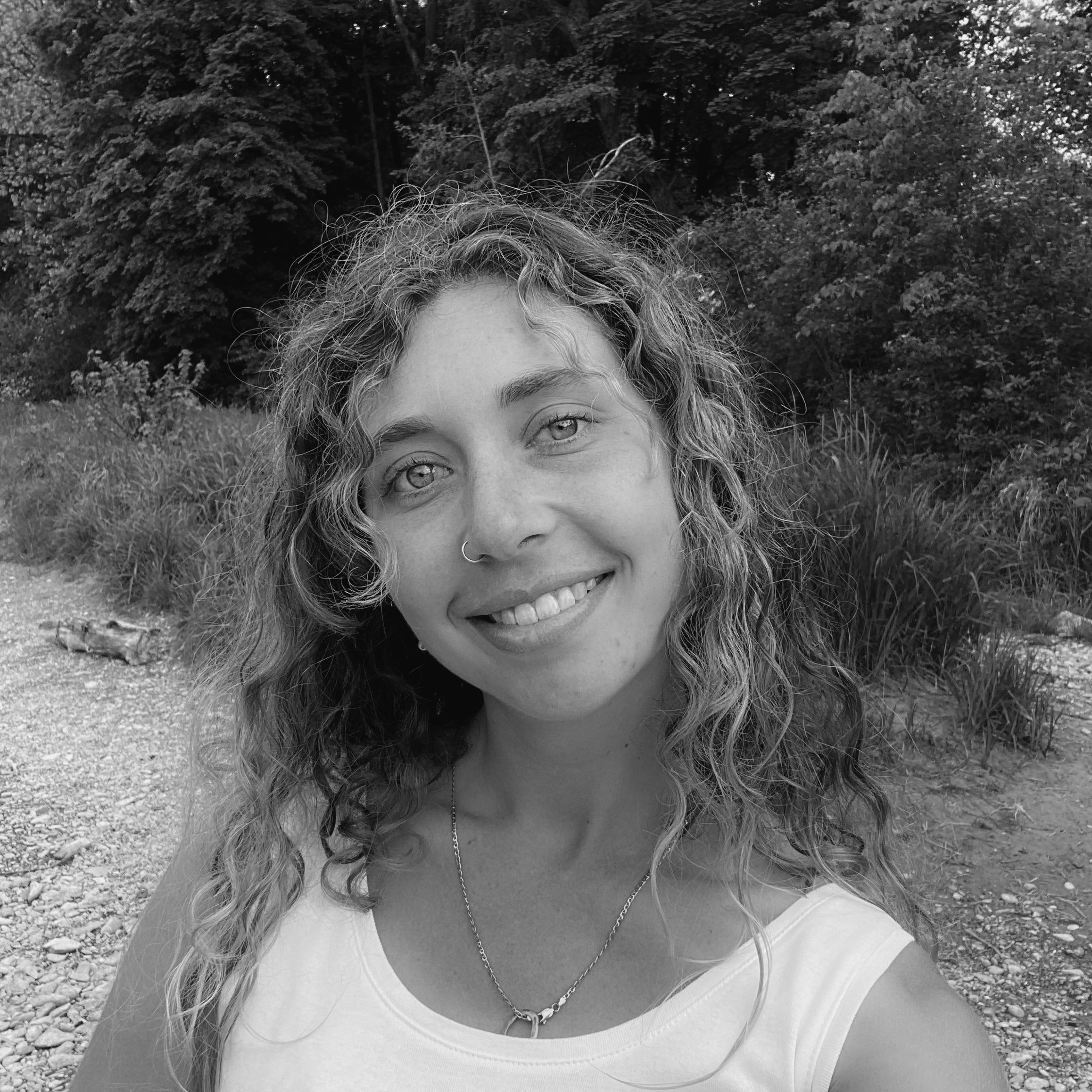 black and white photo of the author smiling at the camera