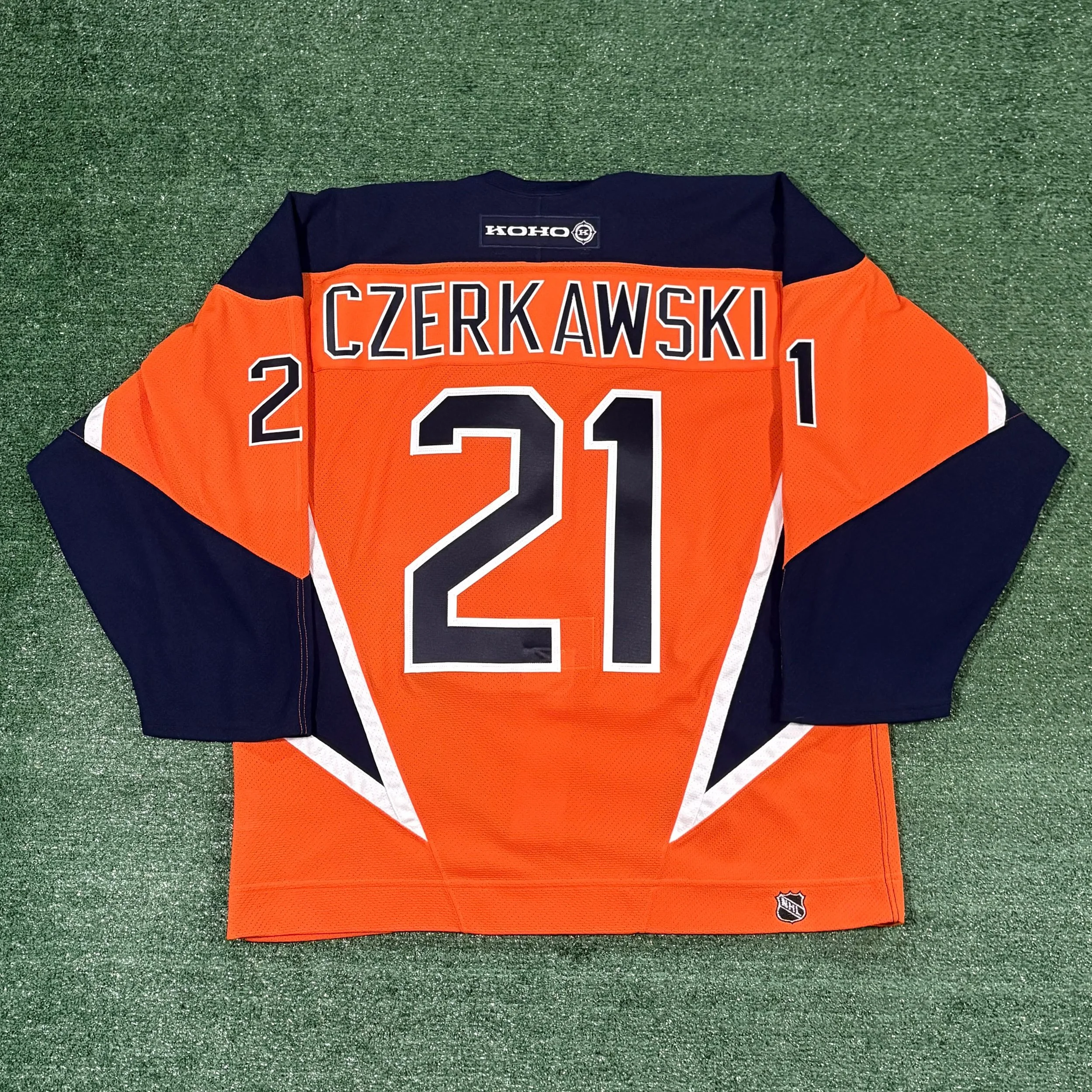 Mariusz Czerkawski Islanders Alternate Jersey

A short-lived alternate, this was certainly a unique design with the so-called &ldquo;daggers&rdquo; on the sides. The Islanders changed the back number (and only the back number) font after 2004 to a mo
