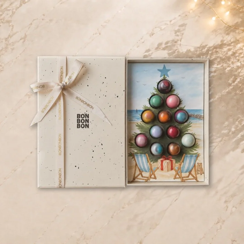 Christmas is coming&hellip; 🎄

And this year, we&rsquo;re giving it a distinctly WA twist.

12 of our signature handcrafted bonbons, boxed as a Christmas tree and set against an iconic Western Australian beach scene &mdash; complete with a little qu