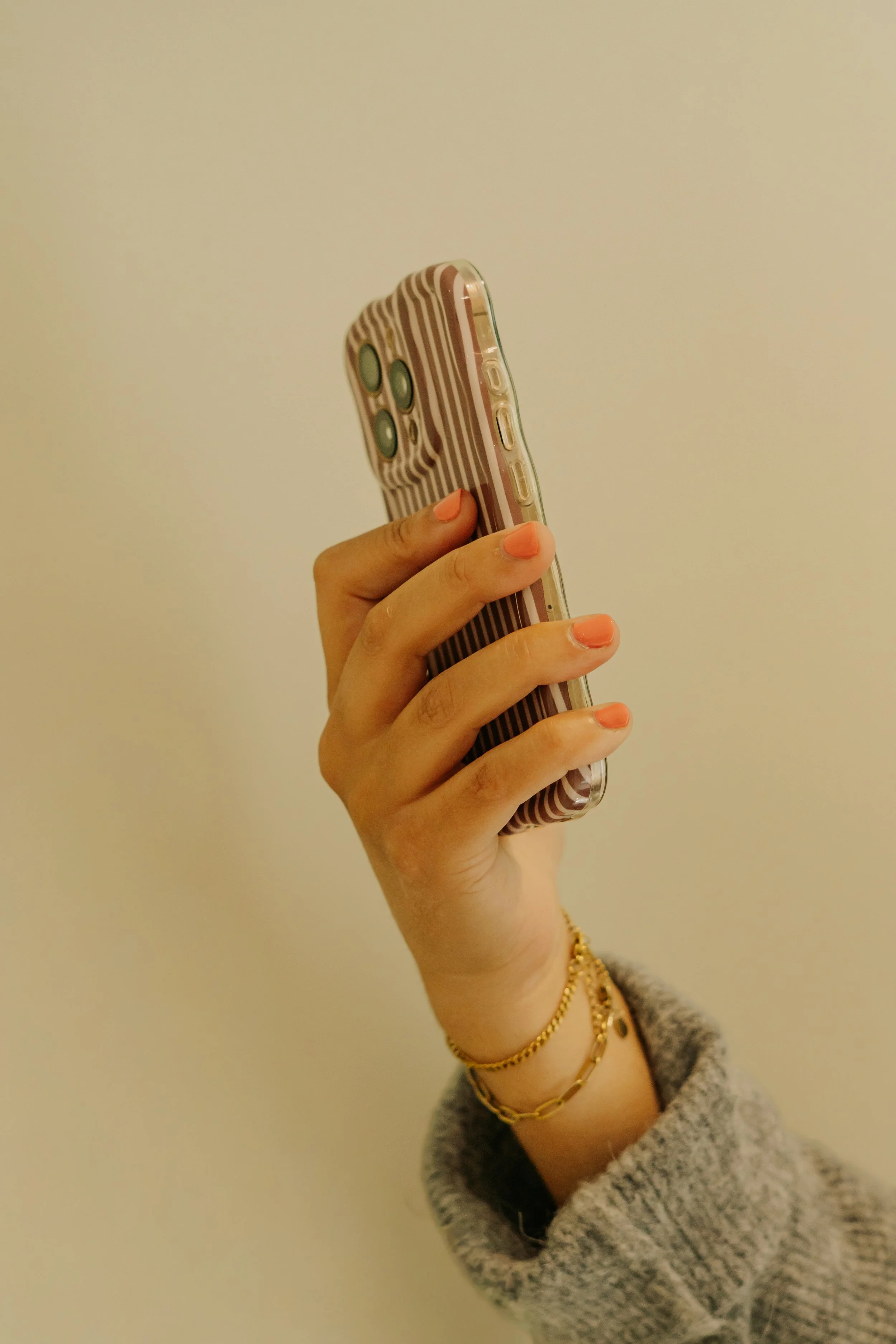person holding phone up against a clear background