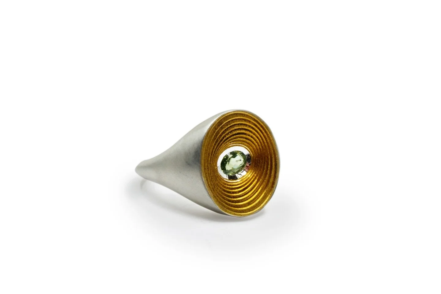The Spiral Signet - 18ct gold centre with a green sapphire, set within a chunky sterling silver ring. On display at the Goldsmiths&rsquo; Centre @gsmithscentre until Wed 18th Feb