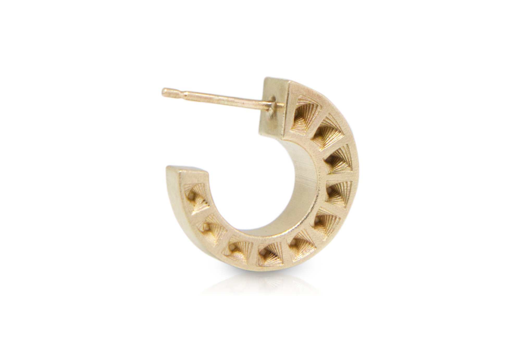 Gold hoop earring with geometric cutouts and a small post for pierced ears.