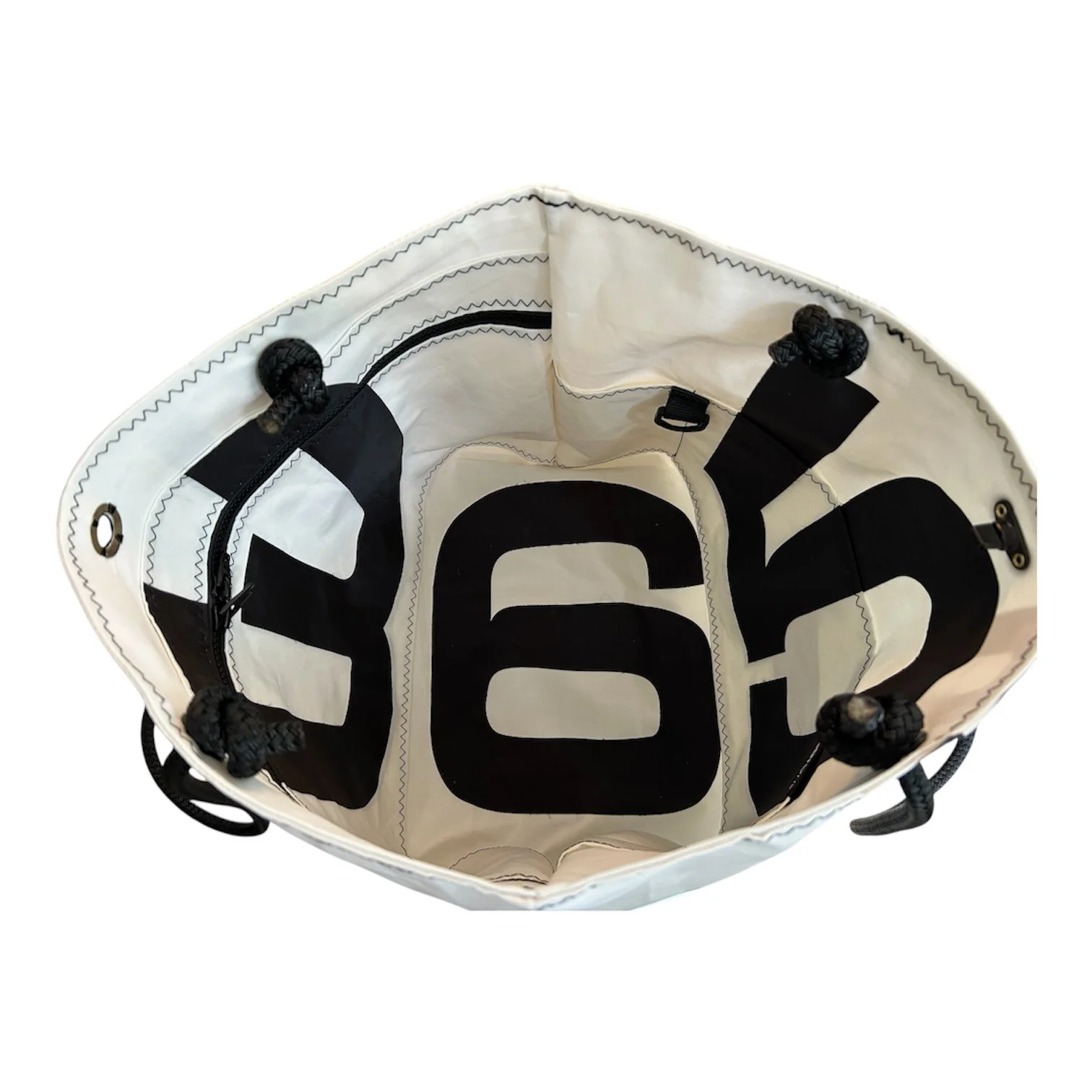 Open tote bag with black and white design, showing interior space and compartments.