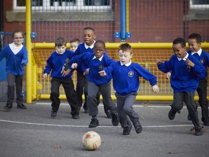 Pupils playing football