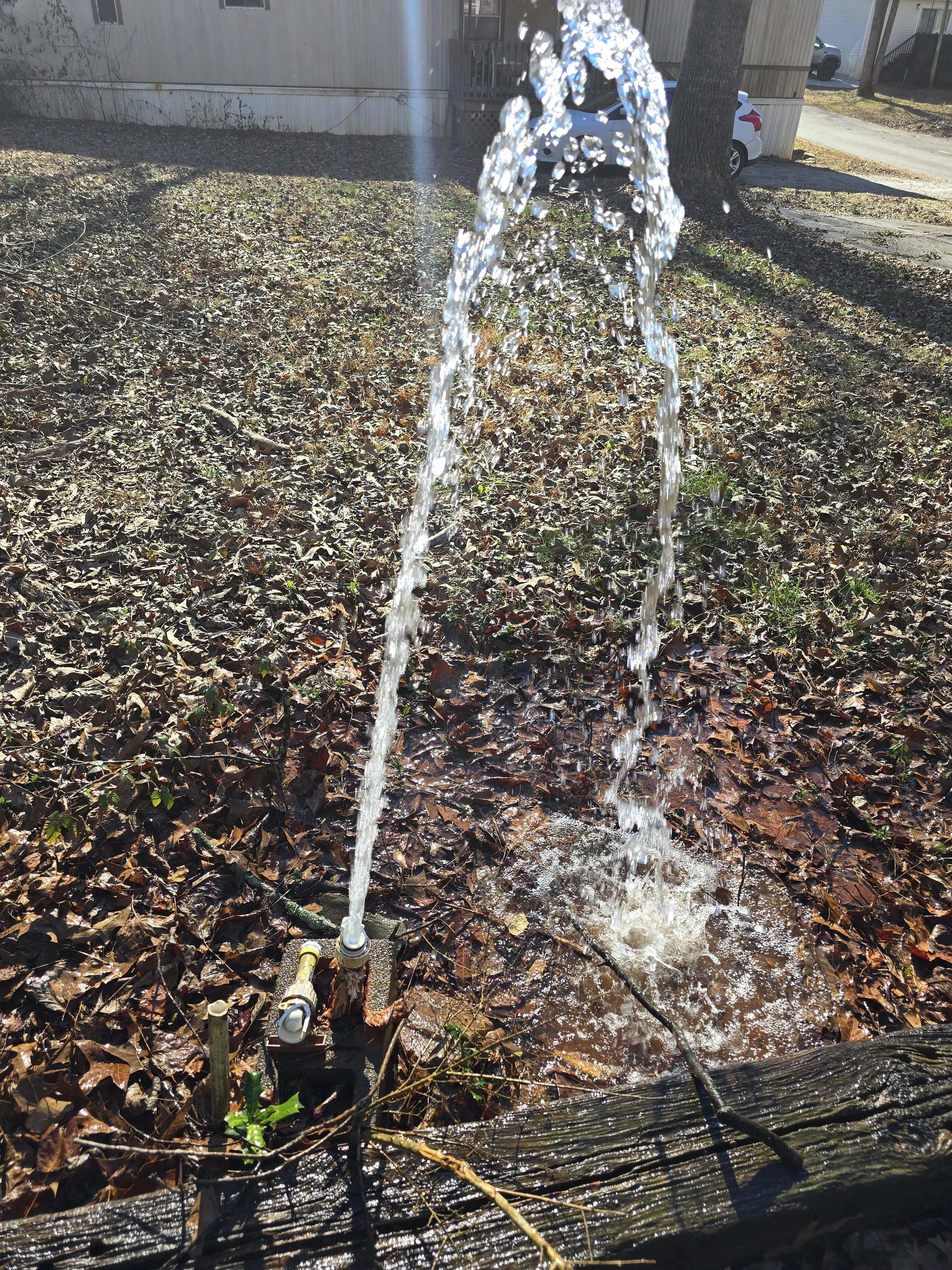 Water line leak repair with water spraying from a damaged pipe