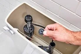 Plumbing repair on a bathroom toilet