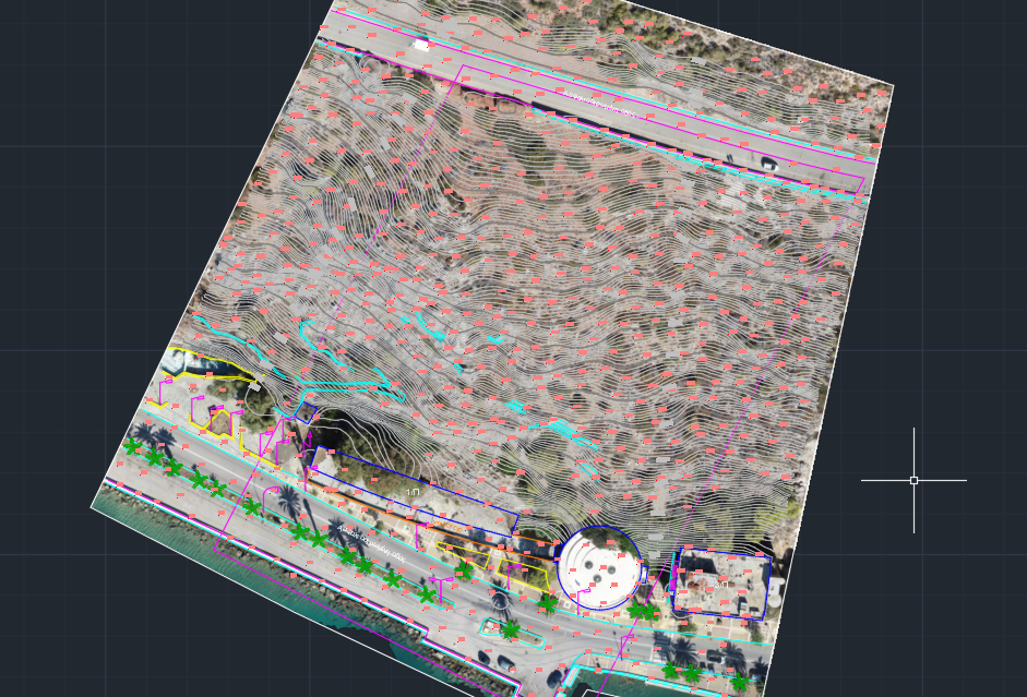Aerial view of a construction or development site with topographical lines, boundary markings, and landscaping features like palm trees along a road.