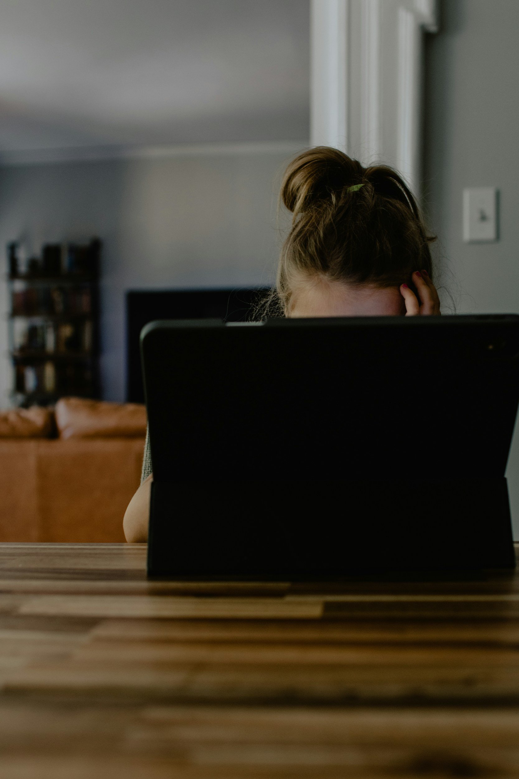 millenial woman researching midcareer change at laptop