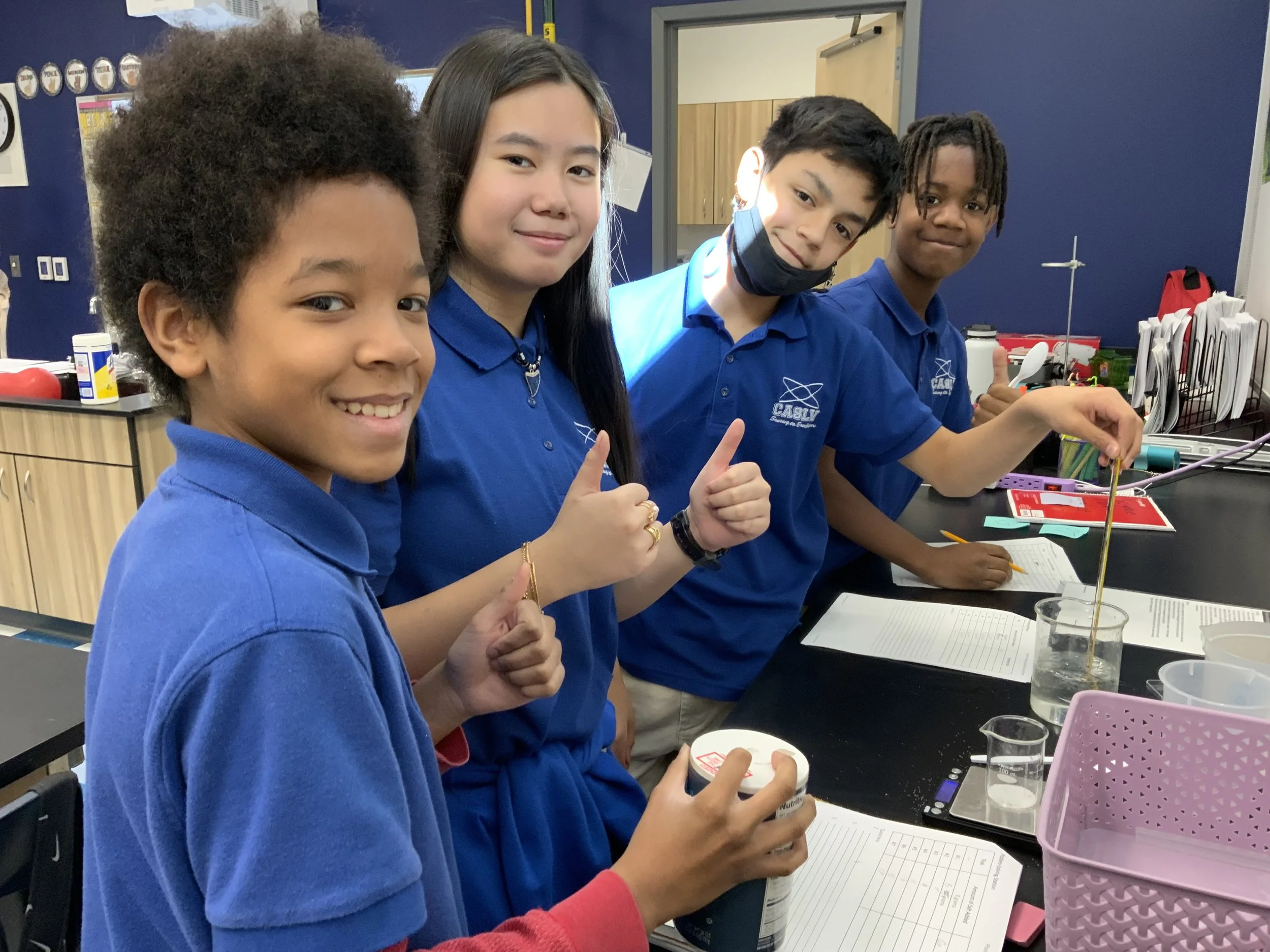 A photo of a teacher helping a student.