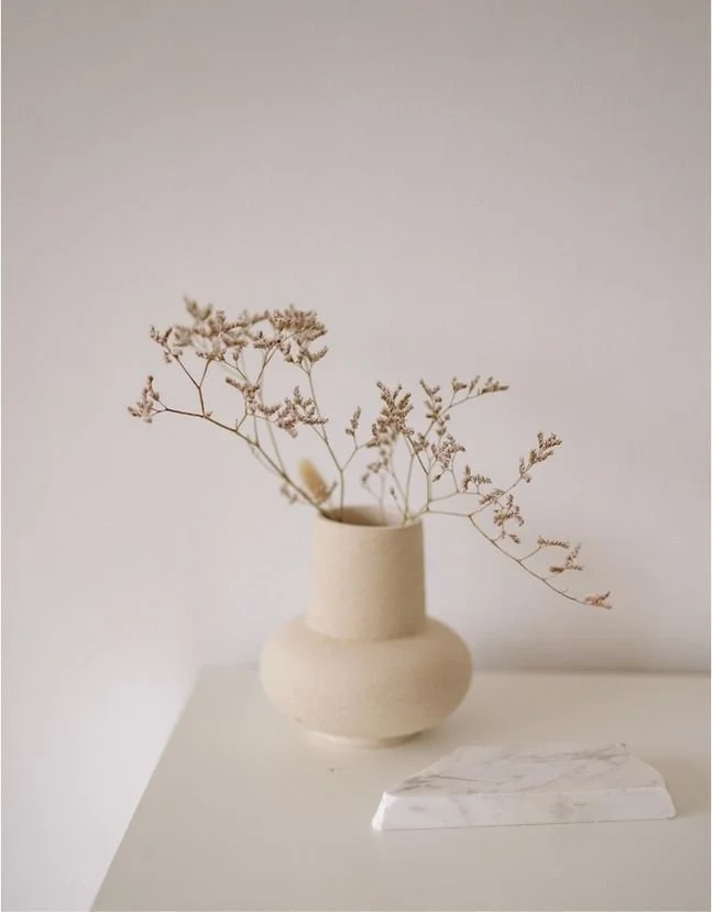 Table with vase and dried flowers