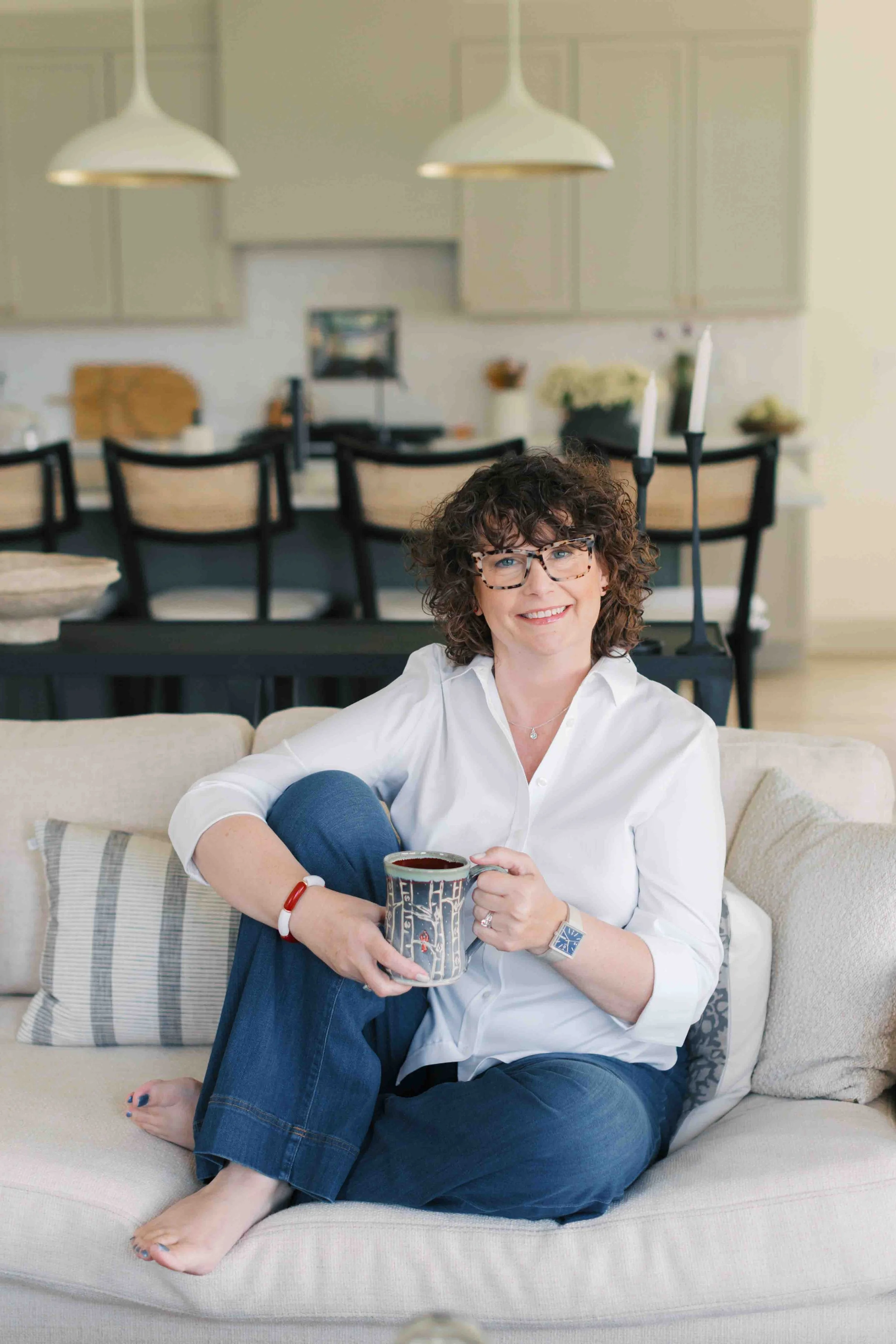 Nichole Alspaugh Williams therapist in Bloomington sitting on a couch with a cup of coffee