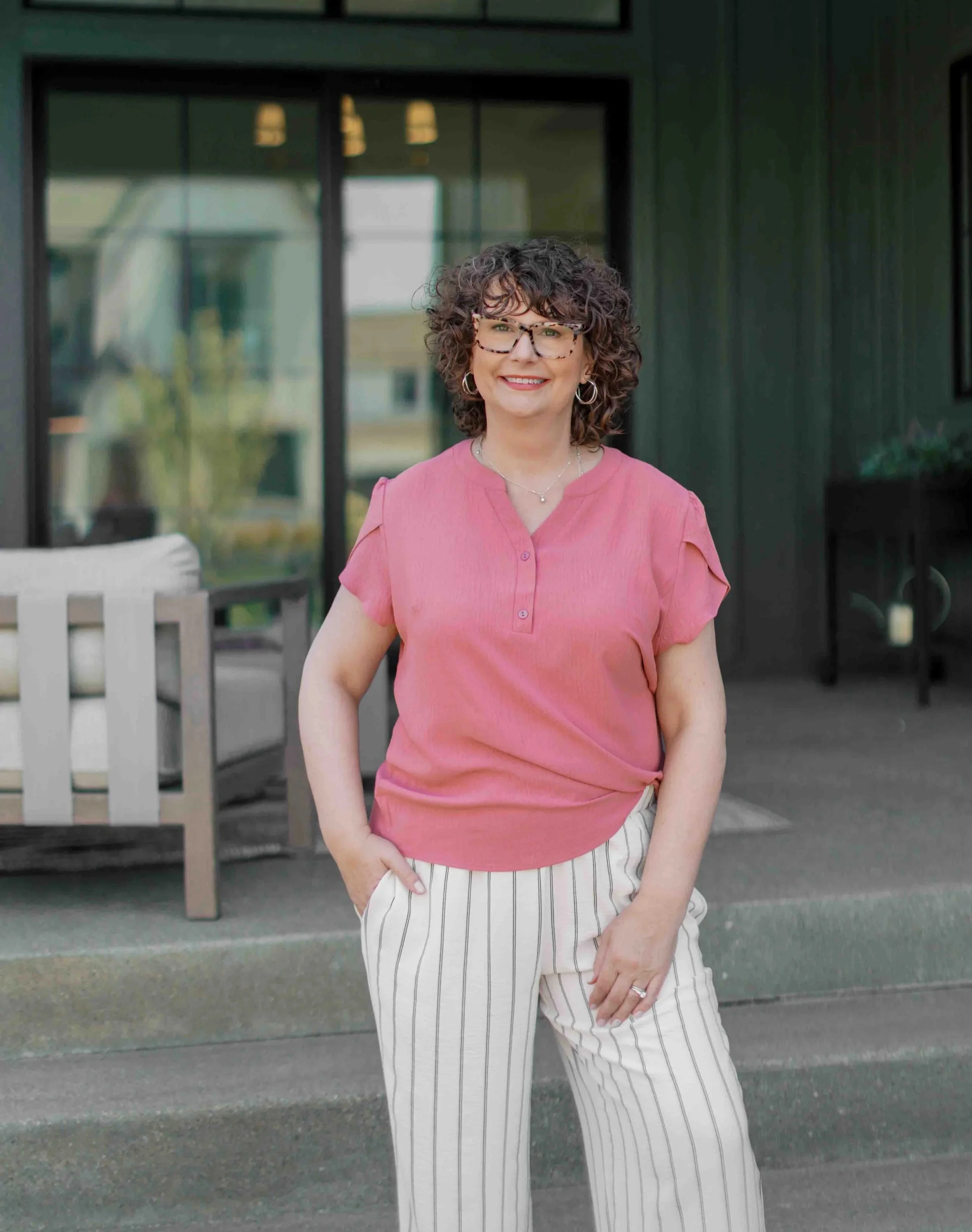 Nichole Alspaugh Williams standing outside and smiling on front porch