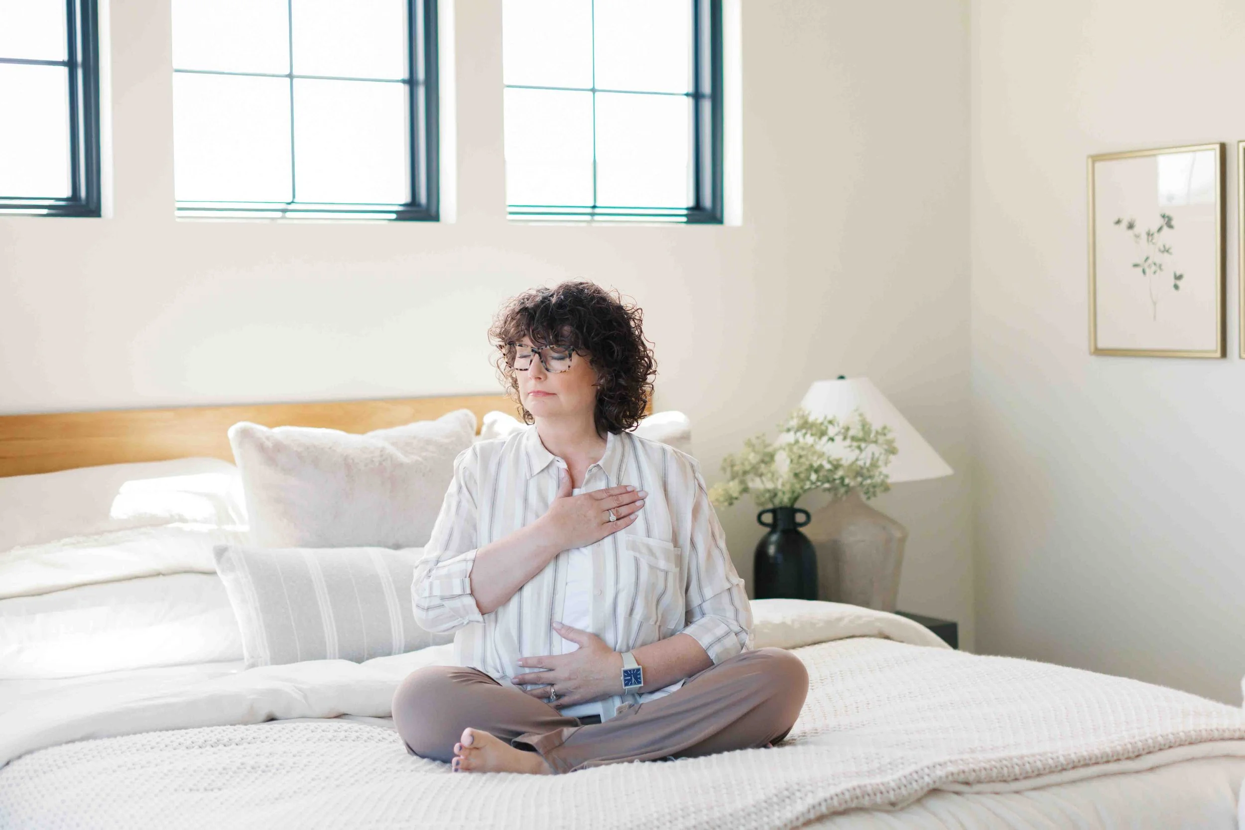 Nichole alspaugh williams therapist sitting on bed in mindfulness pose