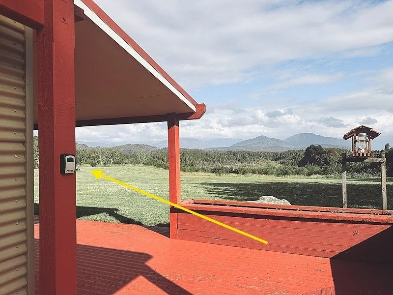 The deck entrance and red lockbox post at Mountain View Retreat
