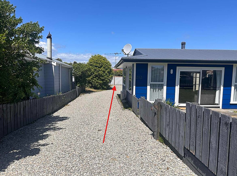 Driveway entrance beside the blue house leading to The Wee Snug