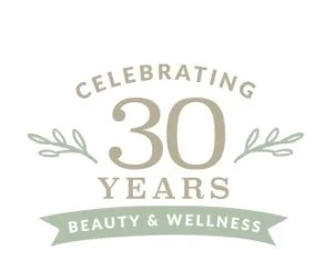 A logo celebrating 30 years with the text 'Celebrating 30 Years Beauty & Wellness' in a circular design with decorative leaves.