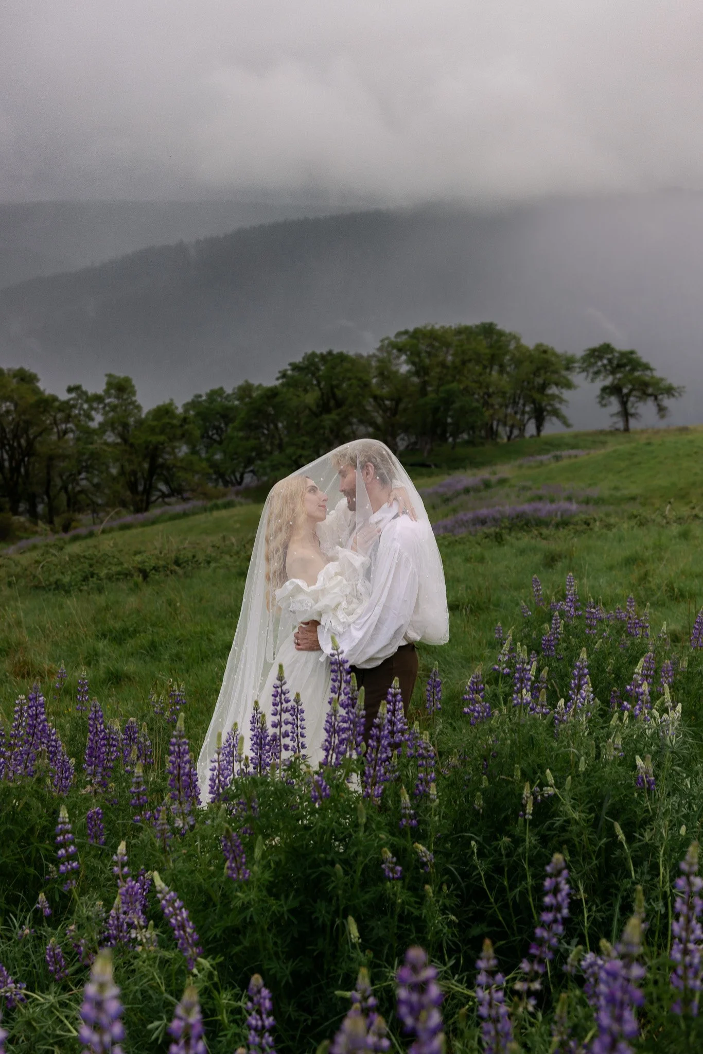 Jessi and Anthony shared their vows together during their elopement in bald hills while there was a lupin flower super bloom.  We shoot between storms and storm clouds were all around us creating a moody and romantic atmosphere