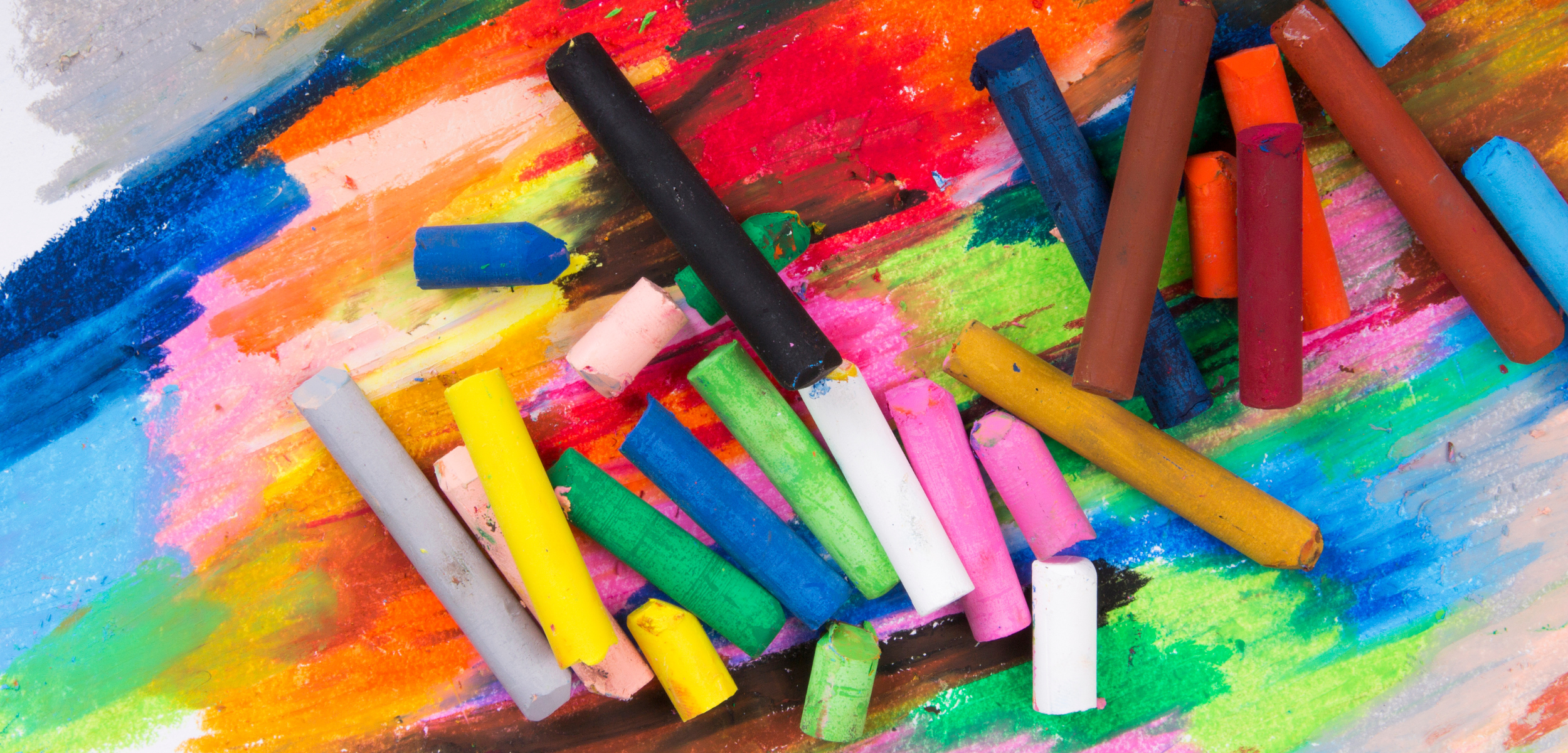 Oil pastels and crayons creating textured lines that give sensory feedback.