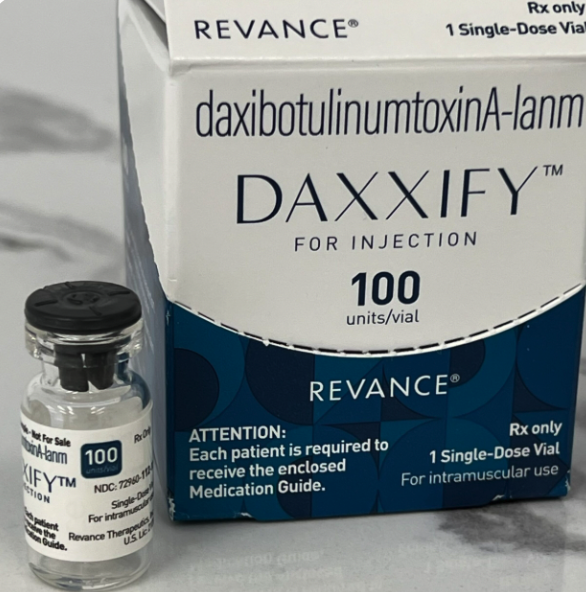 A box of DAXXIFY, a medical injection treatment, and a small vial of the medication labeled "DAXXIFY" with 100 units.