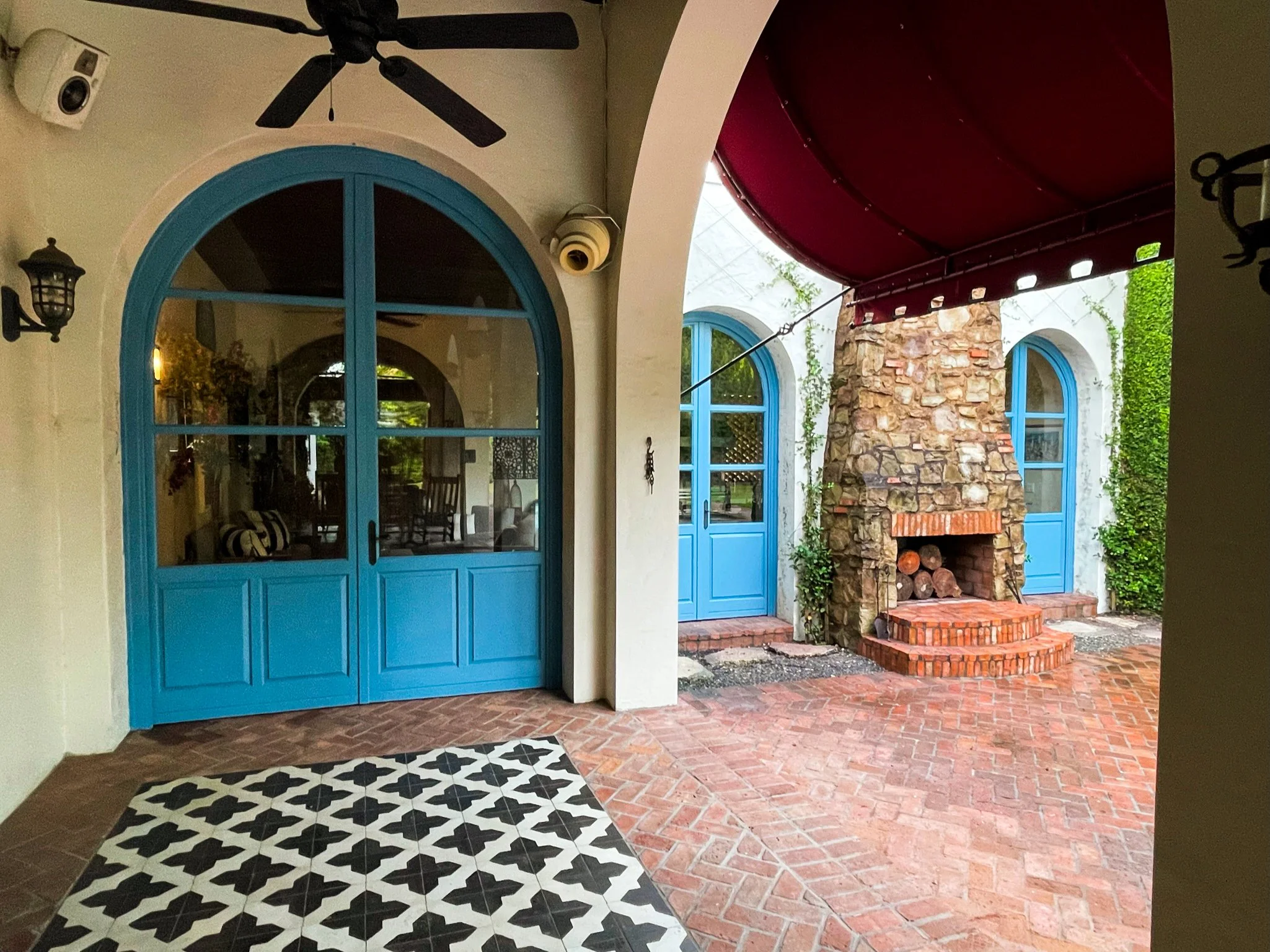 Italian inspired arched doors made from Sapele Wood and painted a light blue.
