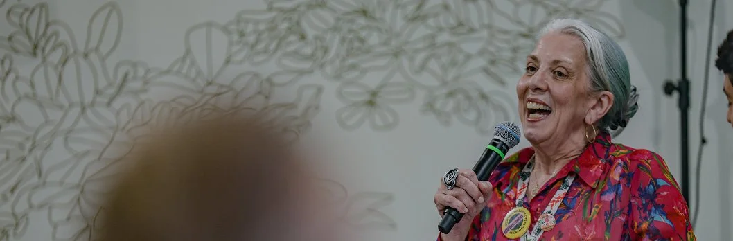 Woman speaking holding microphone