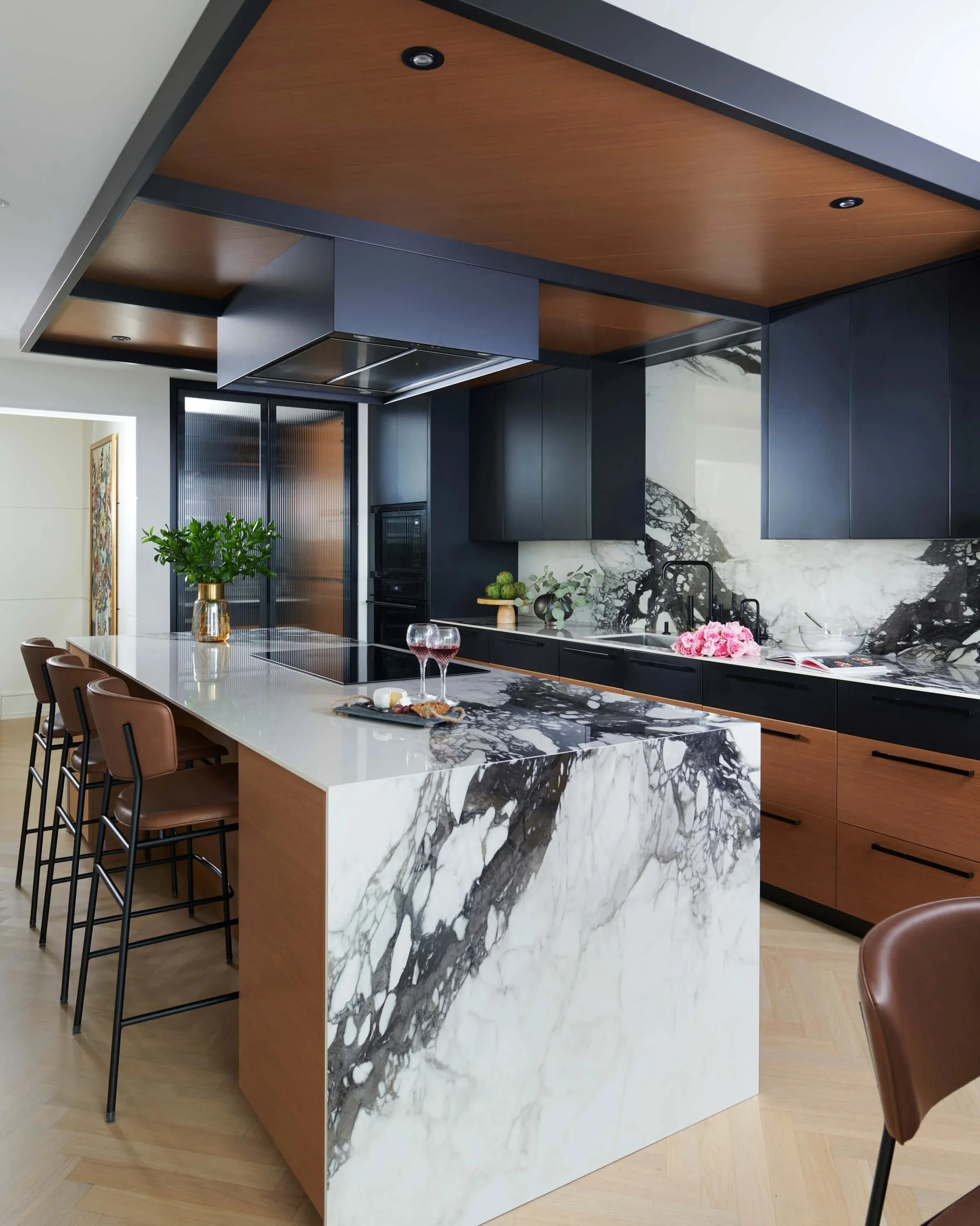 kitchen + black cabinetry + walnut + marble waterfall island + yorkville toronto