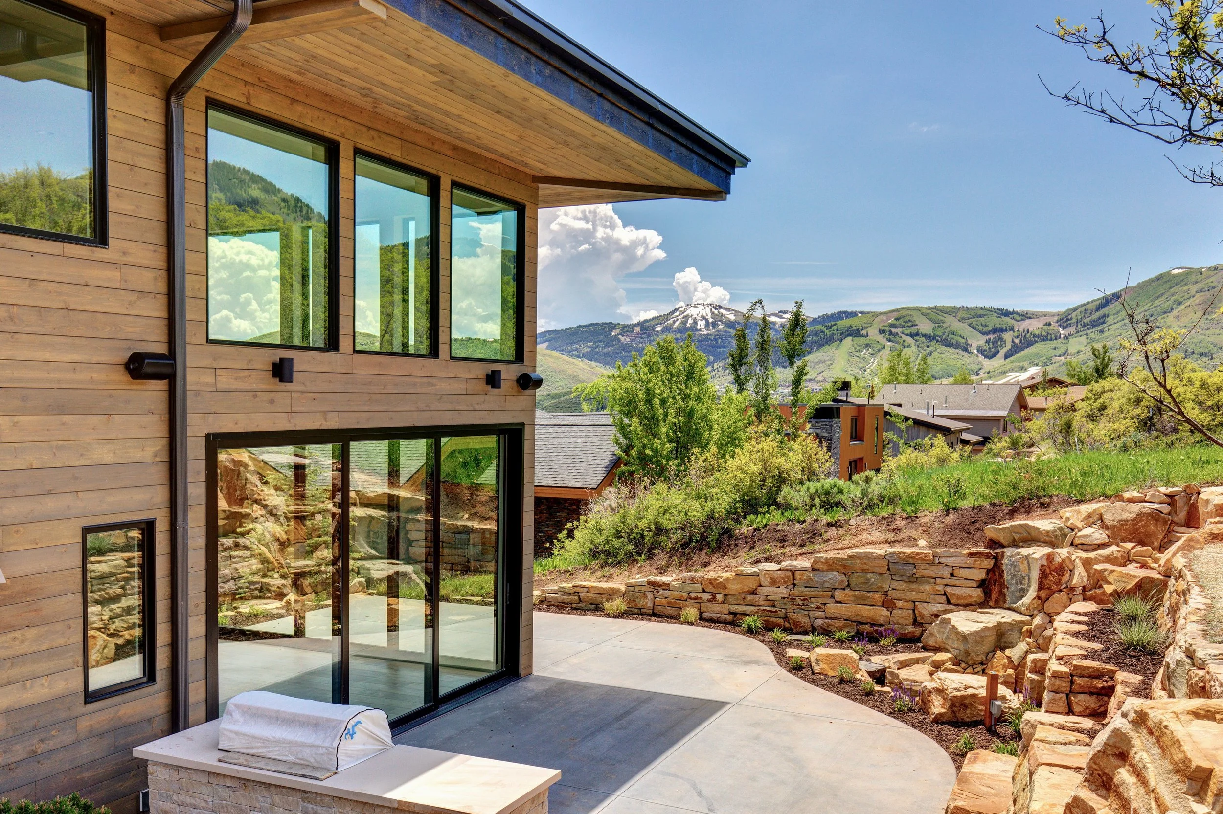 A high performance custom home in the Park City area, exterior view at dusk with mountain views.