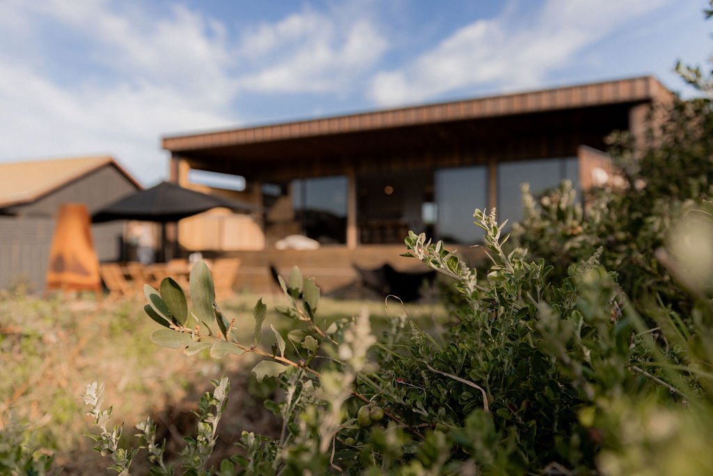 Outdoor seating area with coastal views at Cooinda on the Beach.