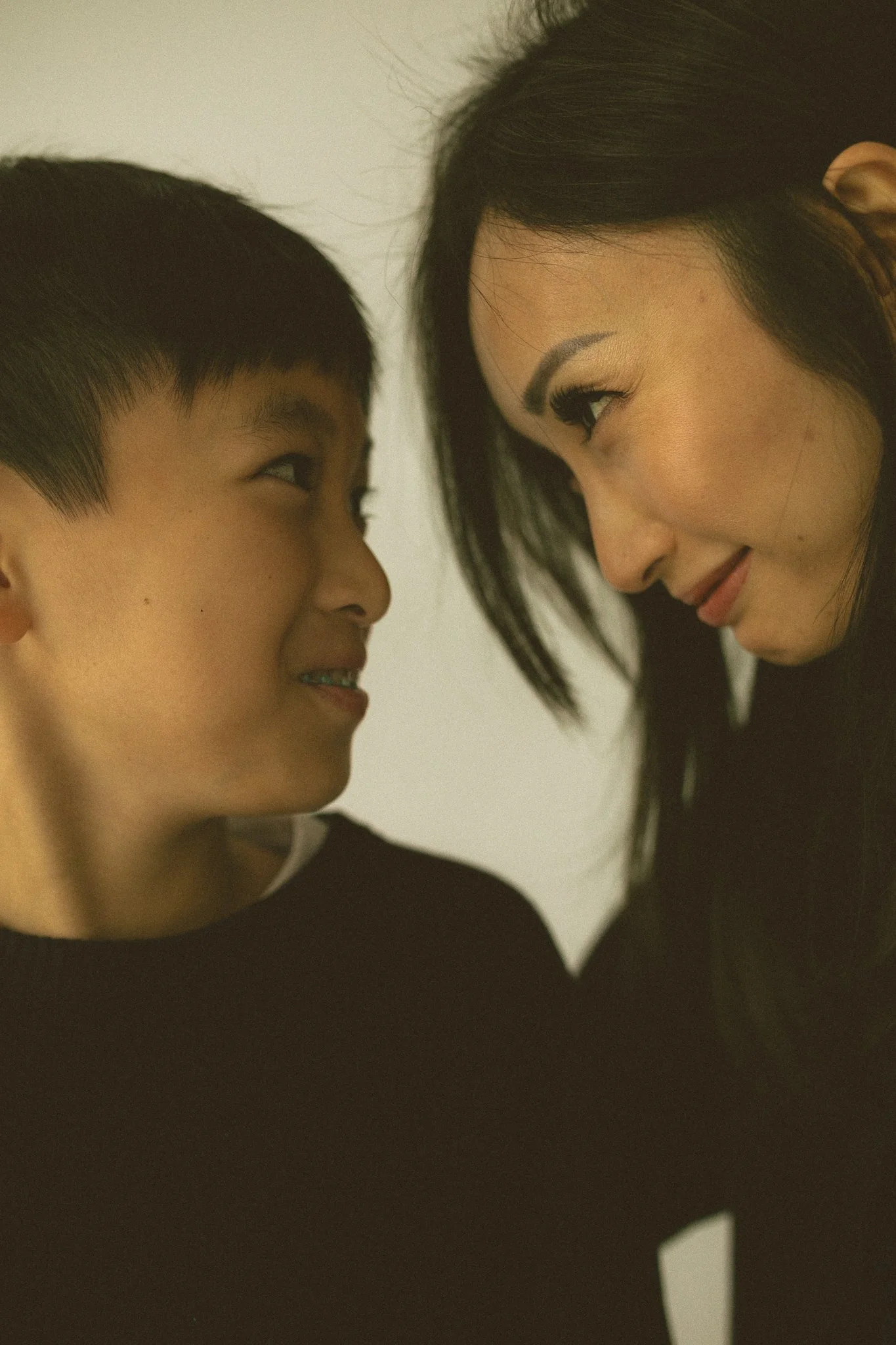 Close-Up of Mother and Son Looking at Each Other, Smiling