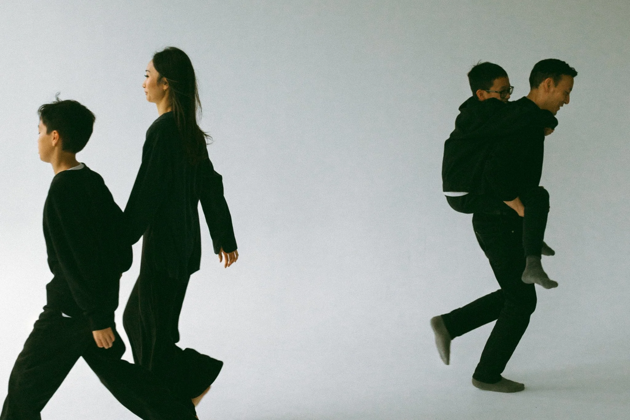 Mother, Father, and Two Sons Walking Together in Studio