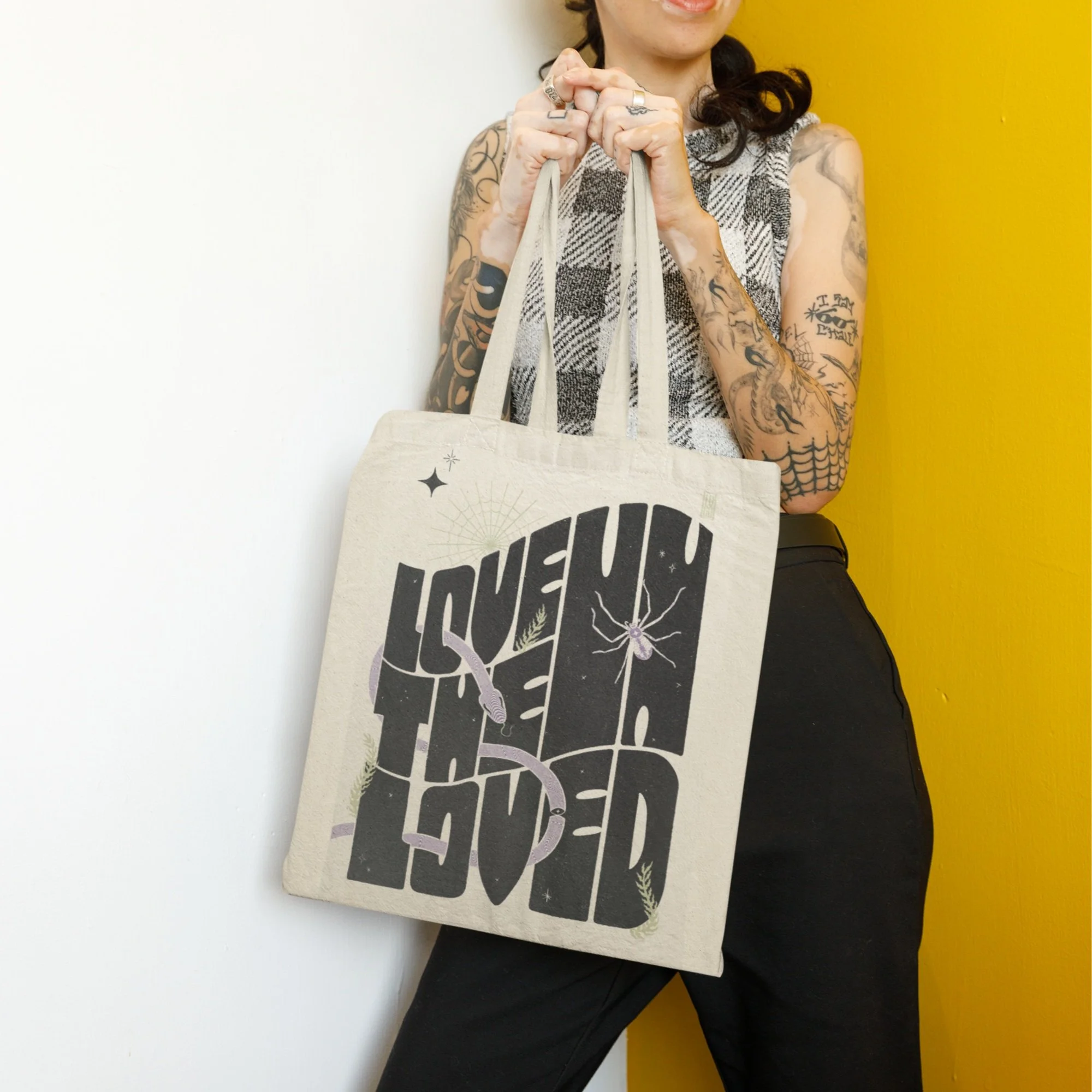 mockup-featuring-a-tattooed-woman-holding-a-sublimated-tote-bag-m31723.jpg