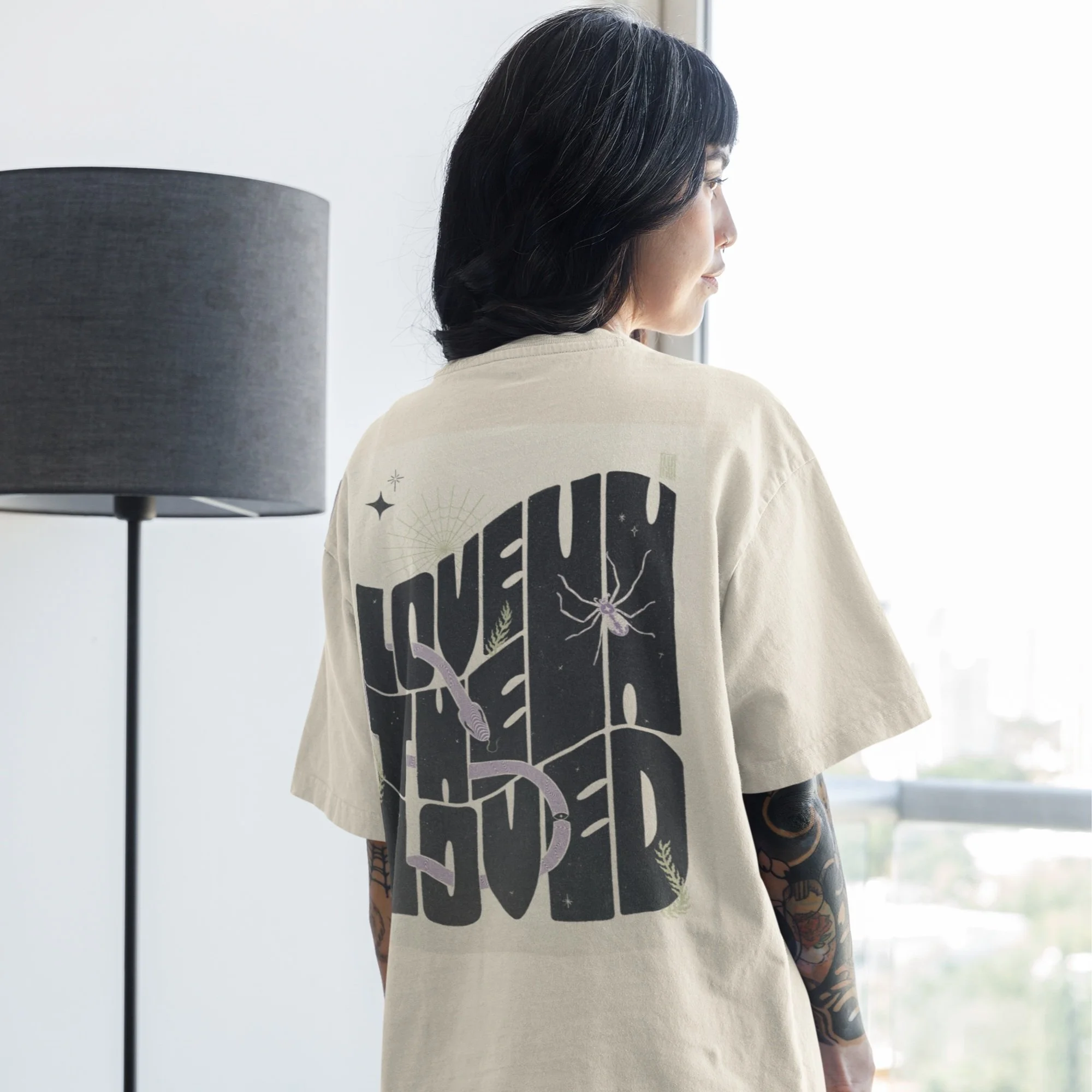 back-view-oversized-t-shirt-mockup-featuring-a-woman-looking-at-a-window-m31702.jpg