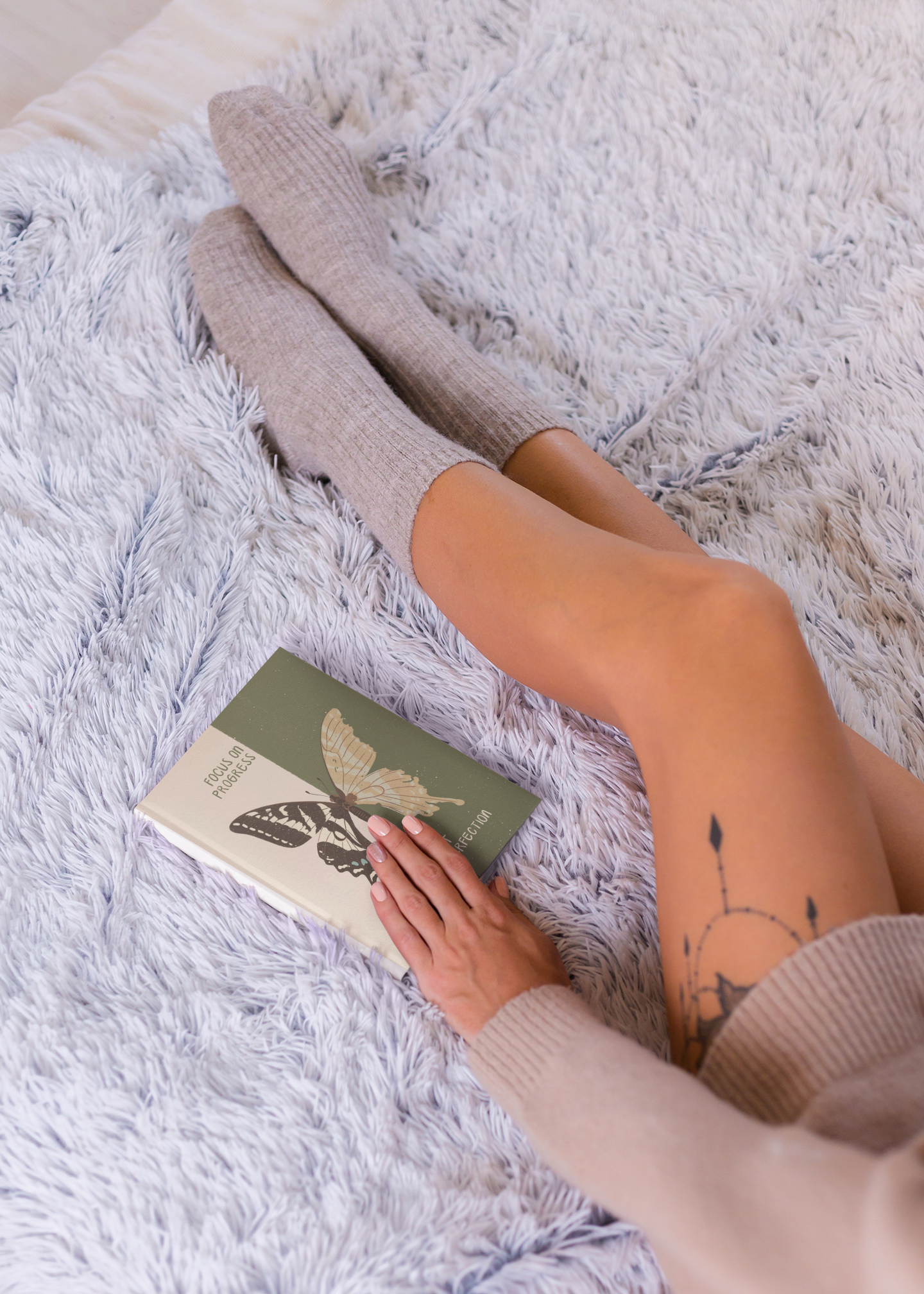 mockup-of-a-woman-with-a-leg-tattoo-with-a-book-on-her-hand-m9372-r-el2.png