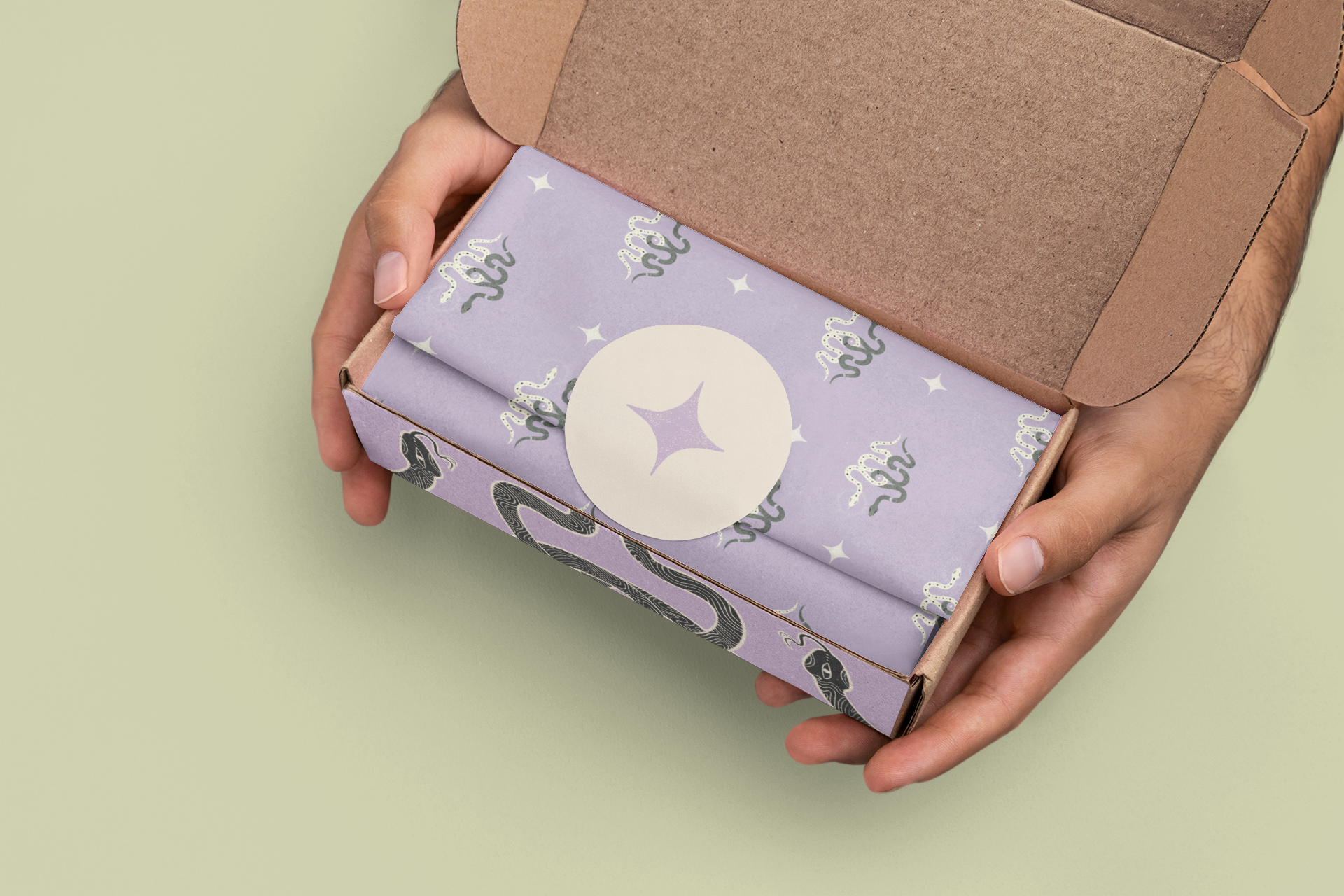 mockup-of-a-man-holding-a-box-with-wrapping-paper-and-a-sticker-m31348 (1).png