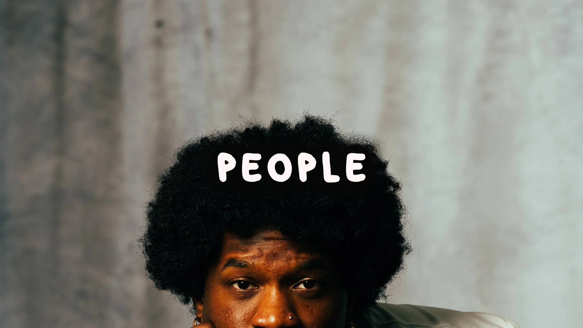 Close-up of a person's face with dark skin, wearing earrings and a nose ring, looking directly at the camera, with the word 'PEOPLE' written above their head in white letters.