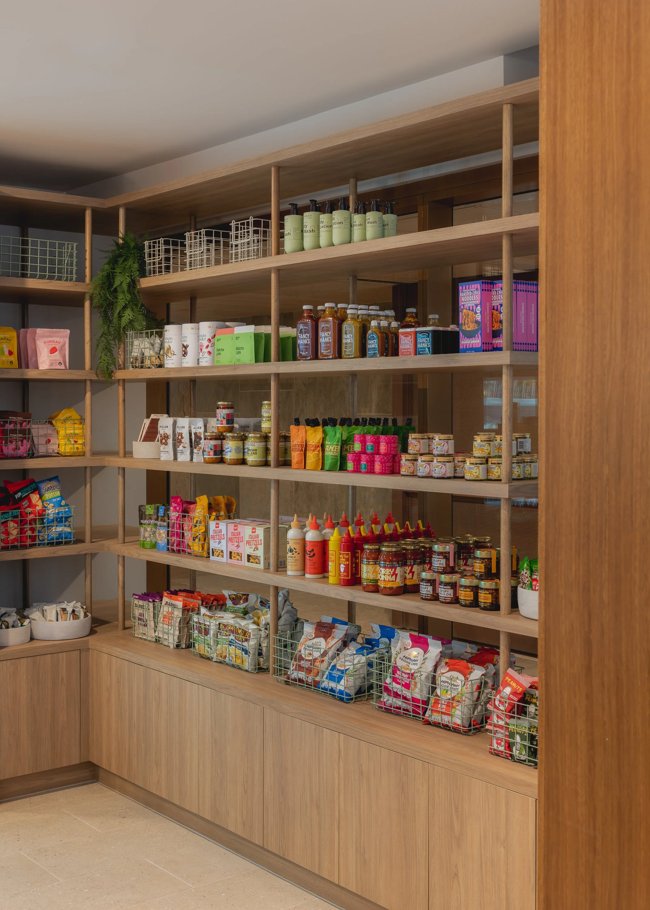 Bespoke timber retail shelving and merchandise display within a Brisbane hospitality fitout.