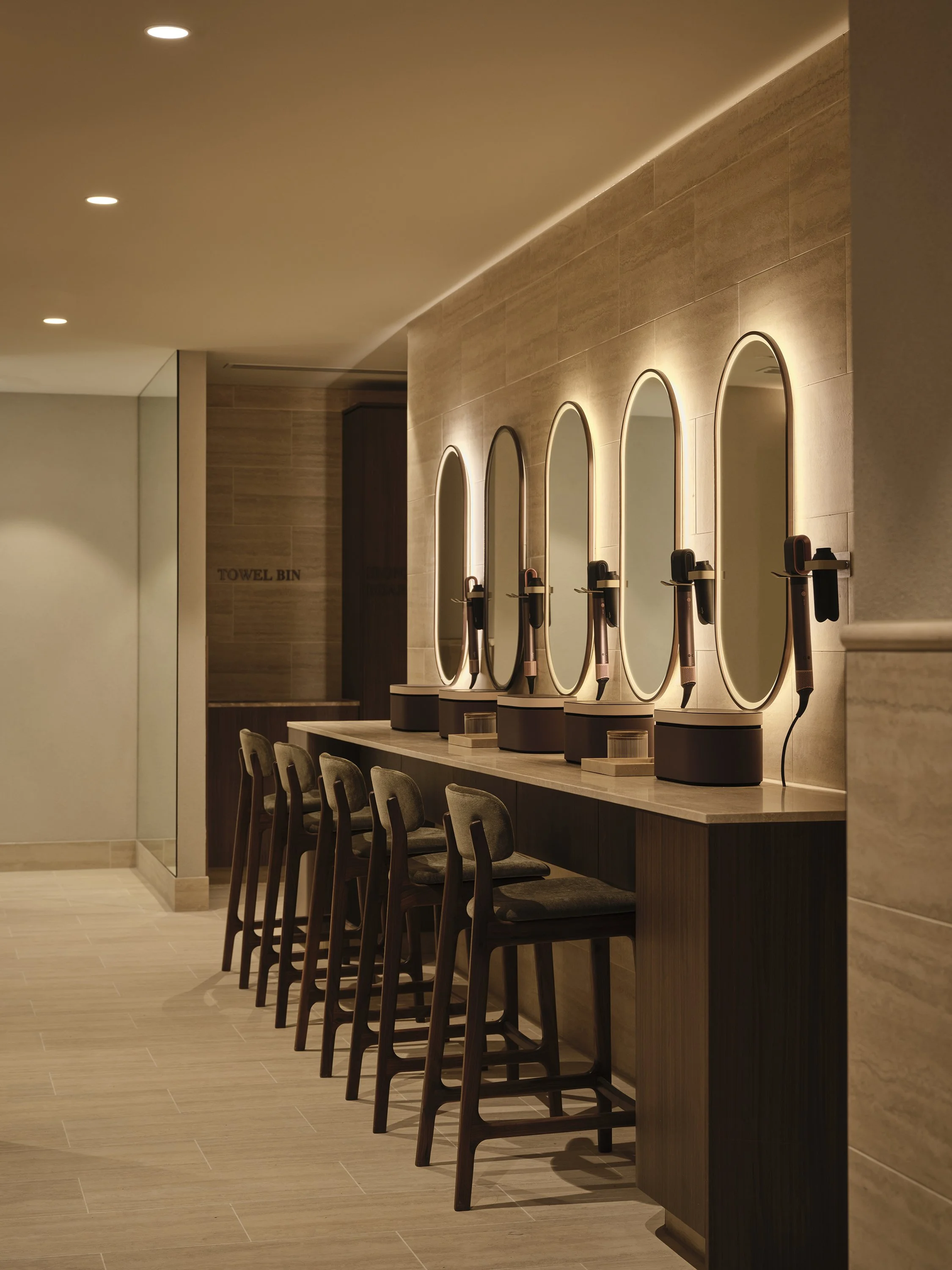 High-end bathroom with soft lighting, and dyson appliances