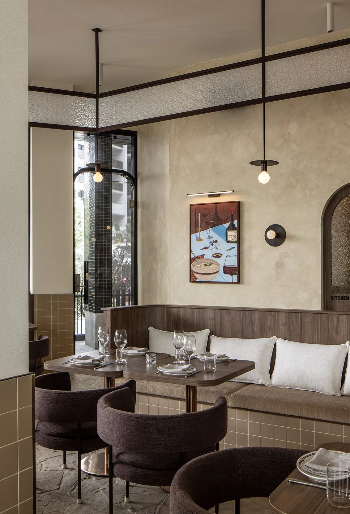 Warm, nostalgic dining space with layered textures and retro Italian influence