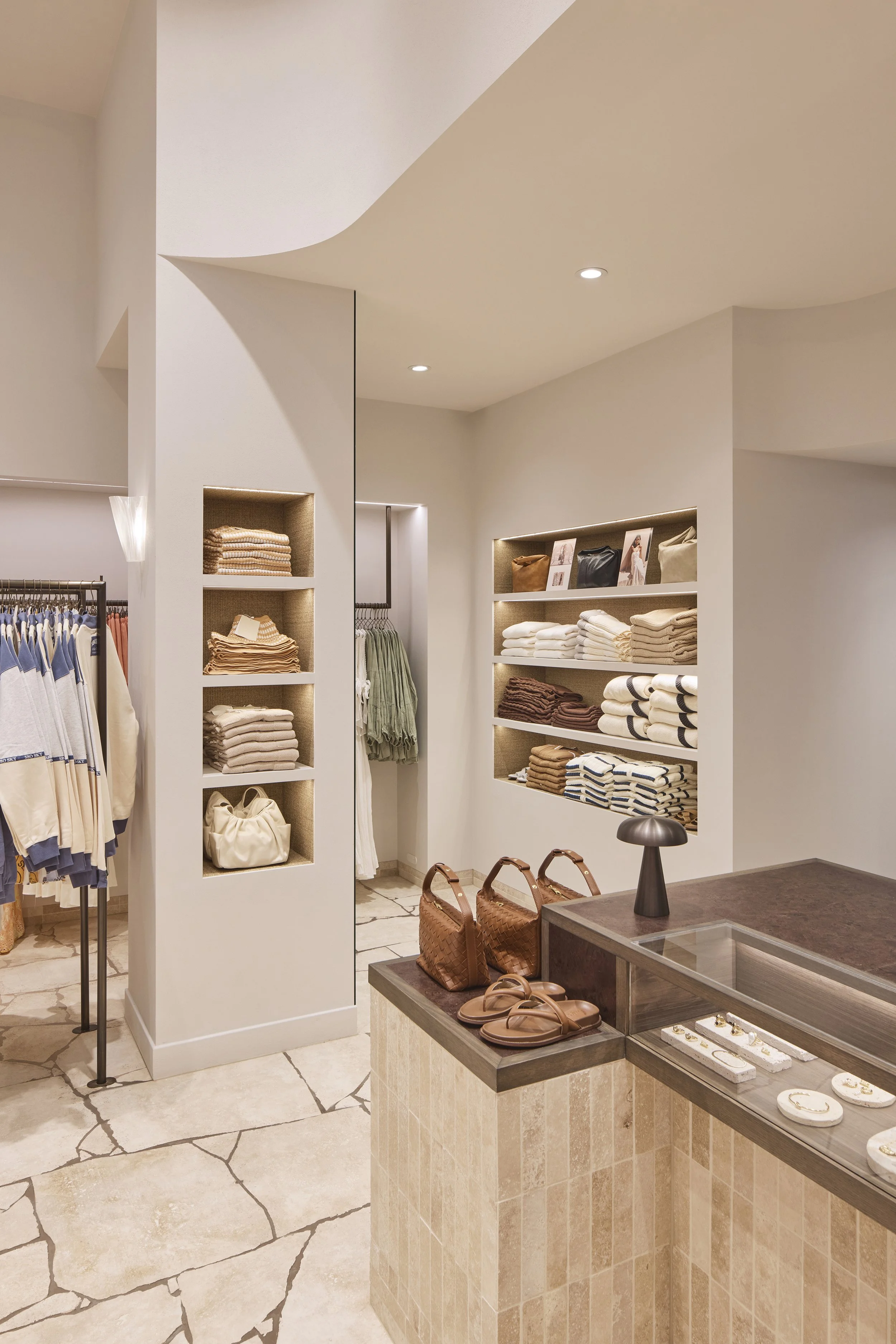 minimal retail space with sculptural forms and soft Mediterranean inspired tones